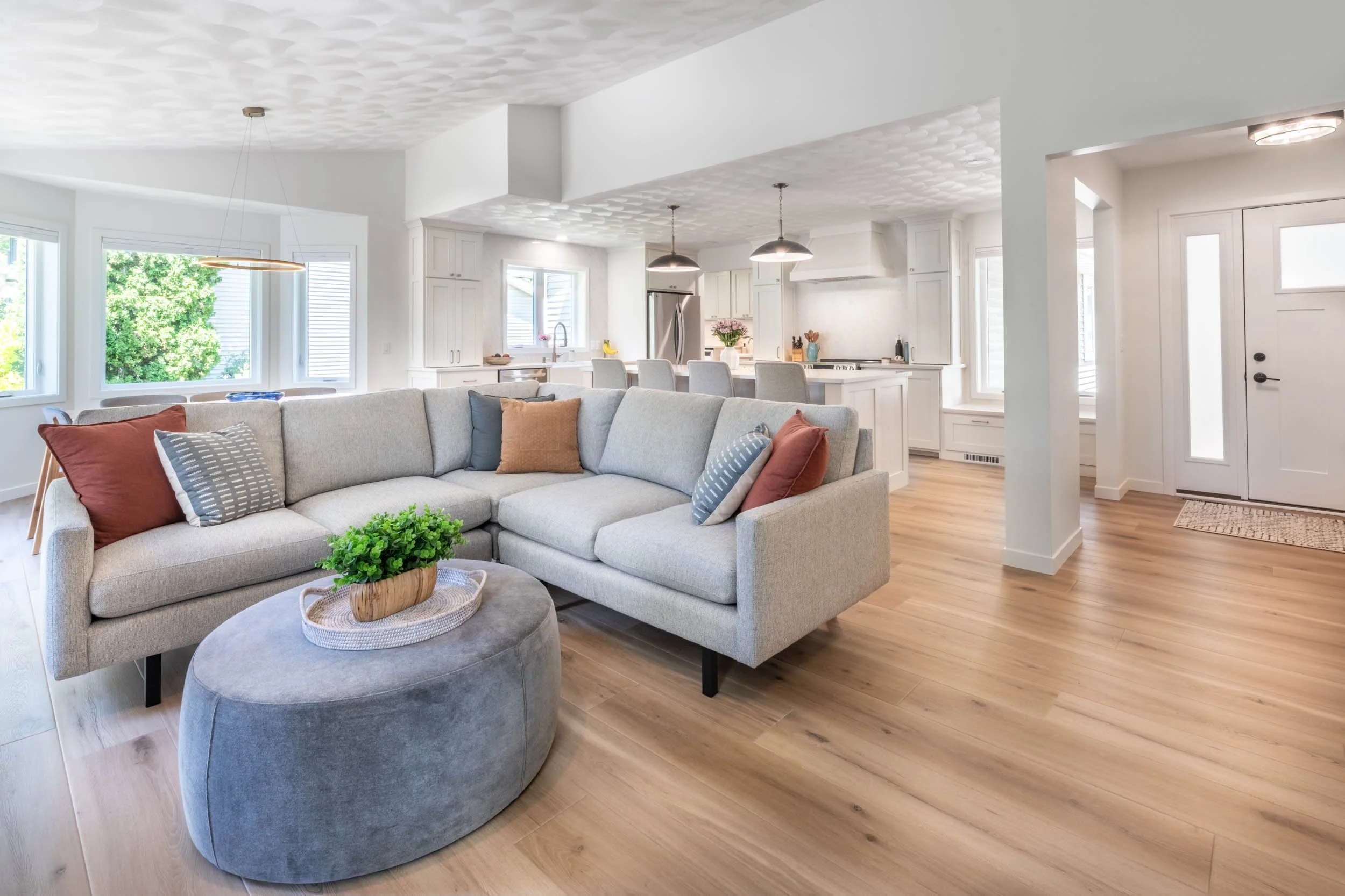 Wide angle view taken from the living room, highlighting the new open floor plan with the kitchen & dining room in the background