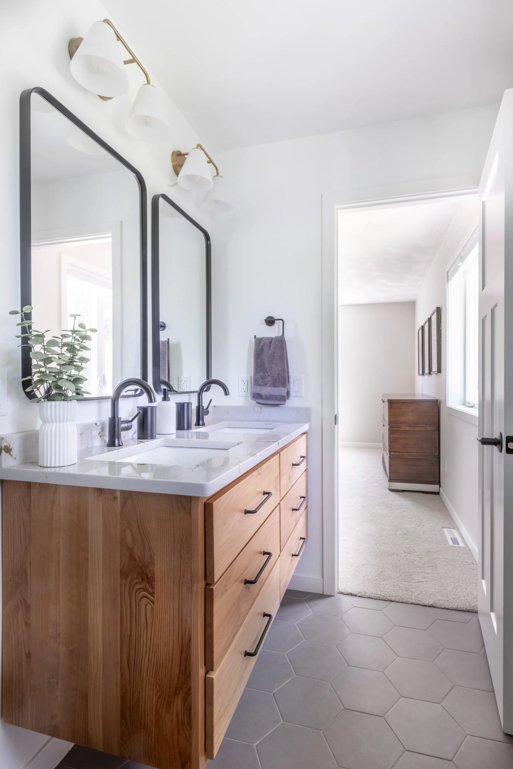 View from the primary bath shower looking towards the bedroom, showcasing the new vanity & Daltile hexagon tile floor