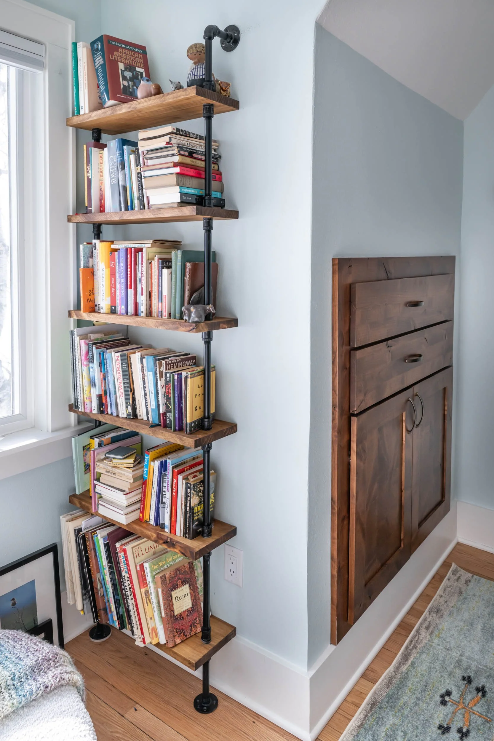 A close up view of the chest of drawers built in the well lit seating area.