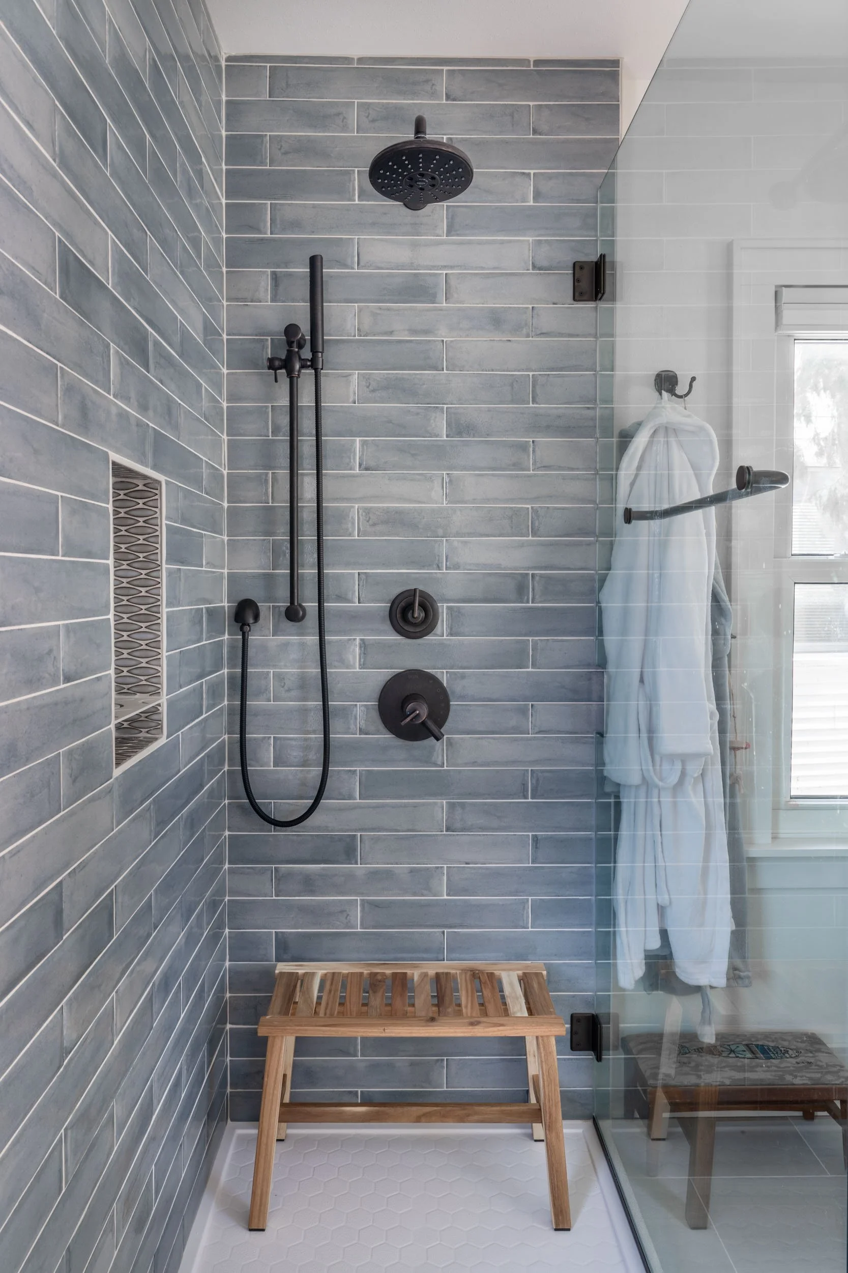The shower wall tile is Lifestyle Del Squal Azzurro 3" x 16" and the shower niche side walls is the Merola Pescado linen in grey mosaic.