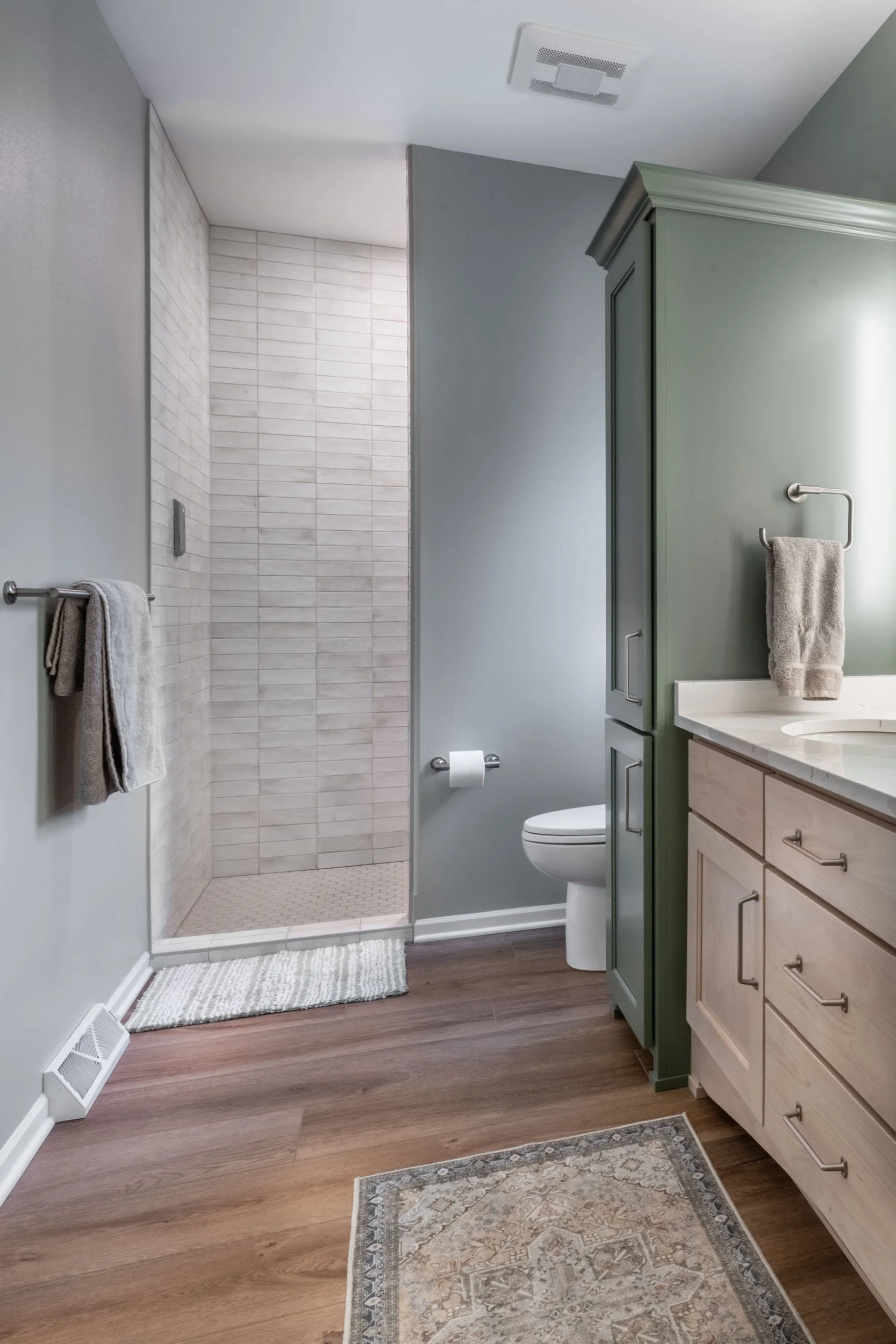 The shower wall tile is Equipe Hanoi White, 3x8 in a horizontally stacked pattern.