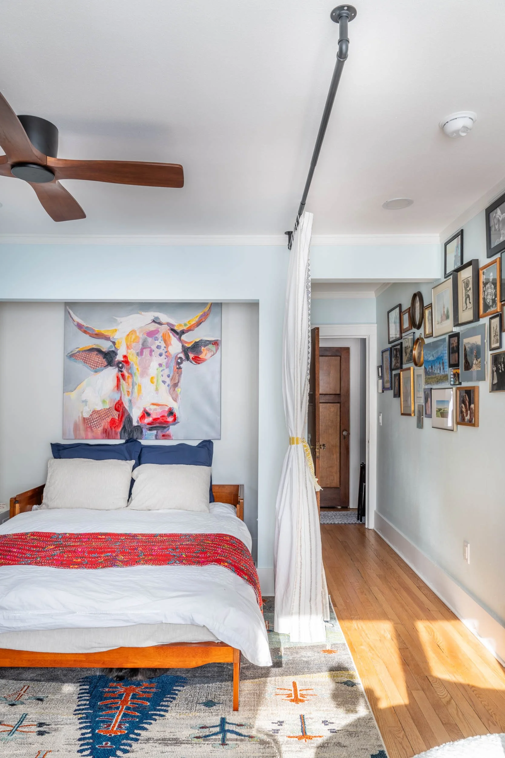 A view of the multi-purpose guest bedroom with a Murphy bed and hallway.