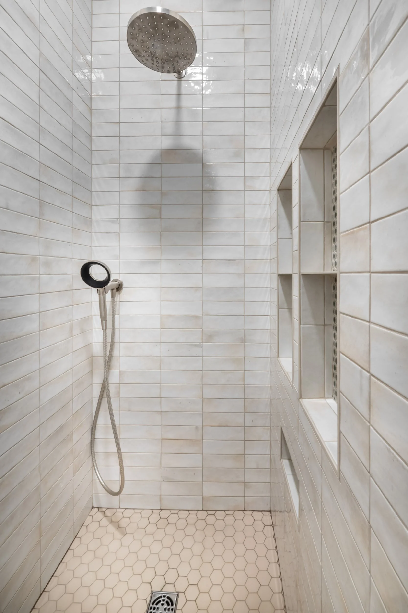The shower floor tile is Daltile Keystones 2” hexagon in Elemental Tan