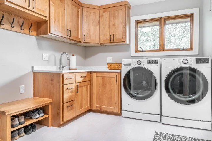Laundry room with wash sink and shoe storage bench