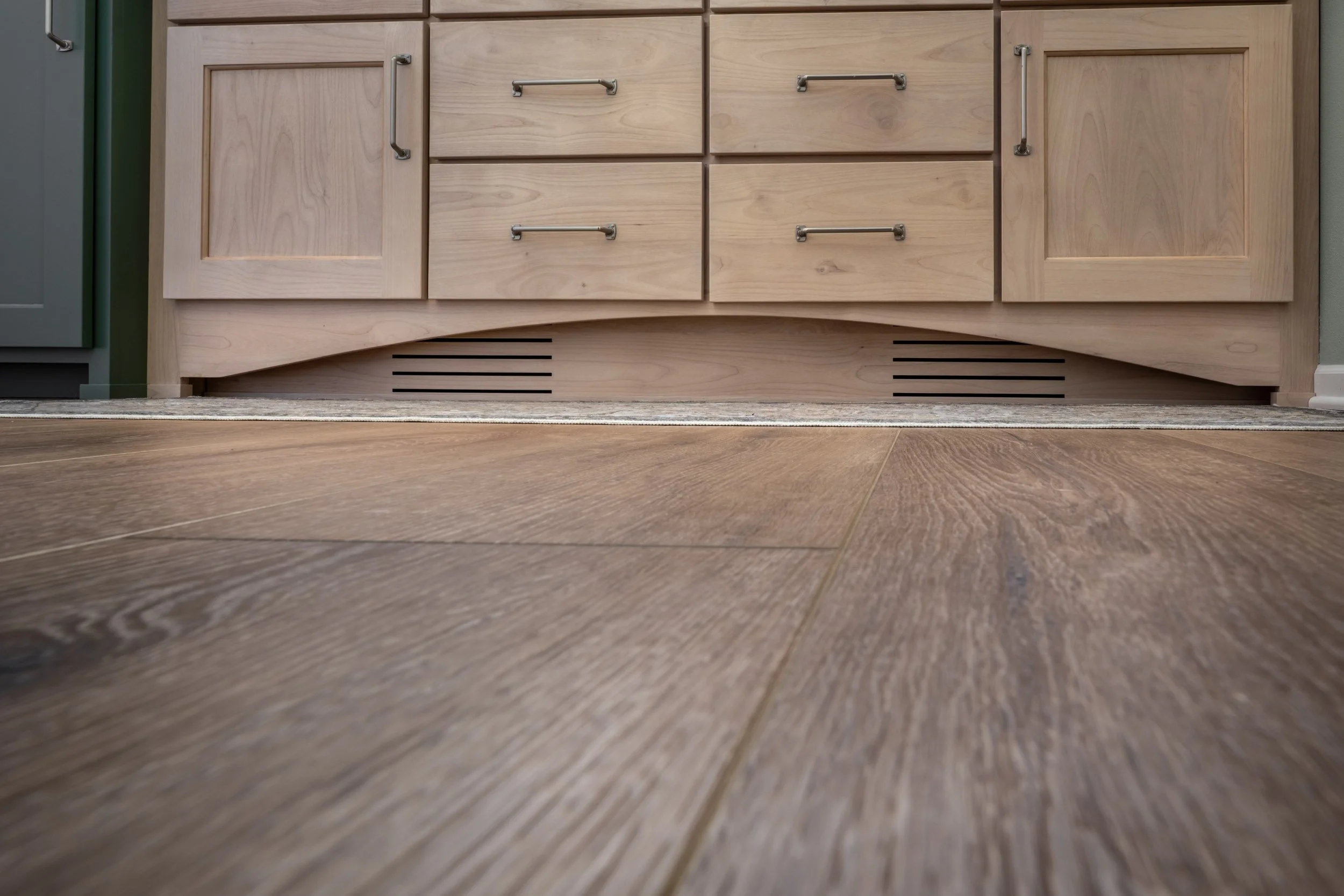 The slats in the bottom of the vanity are for the toe kick ventilation.