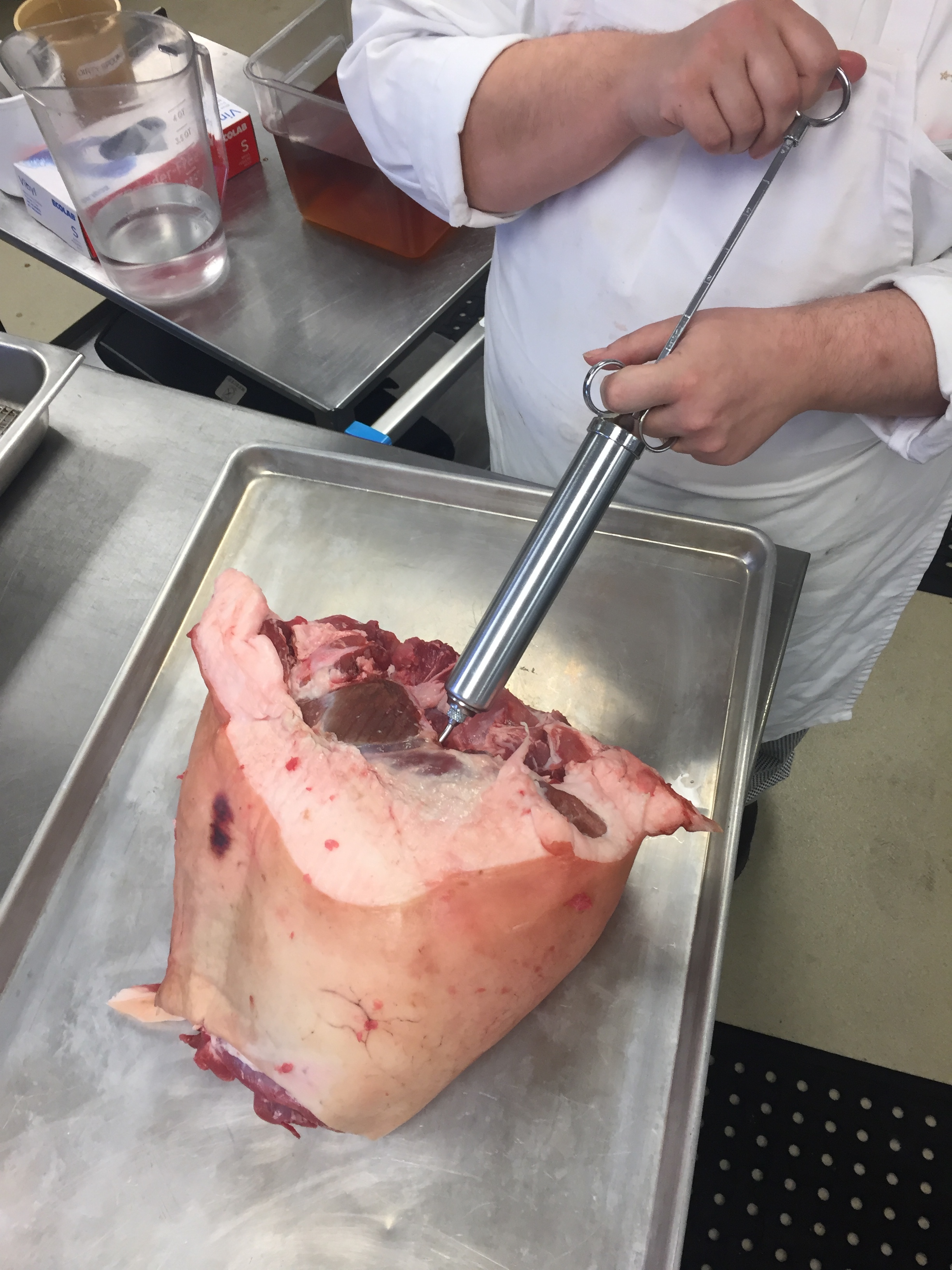 Injecting a ham with brine