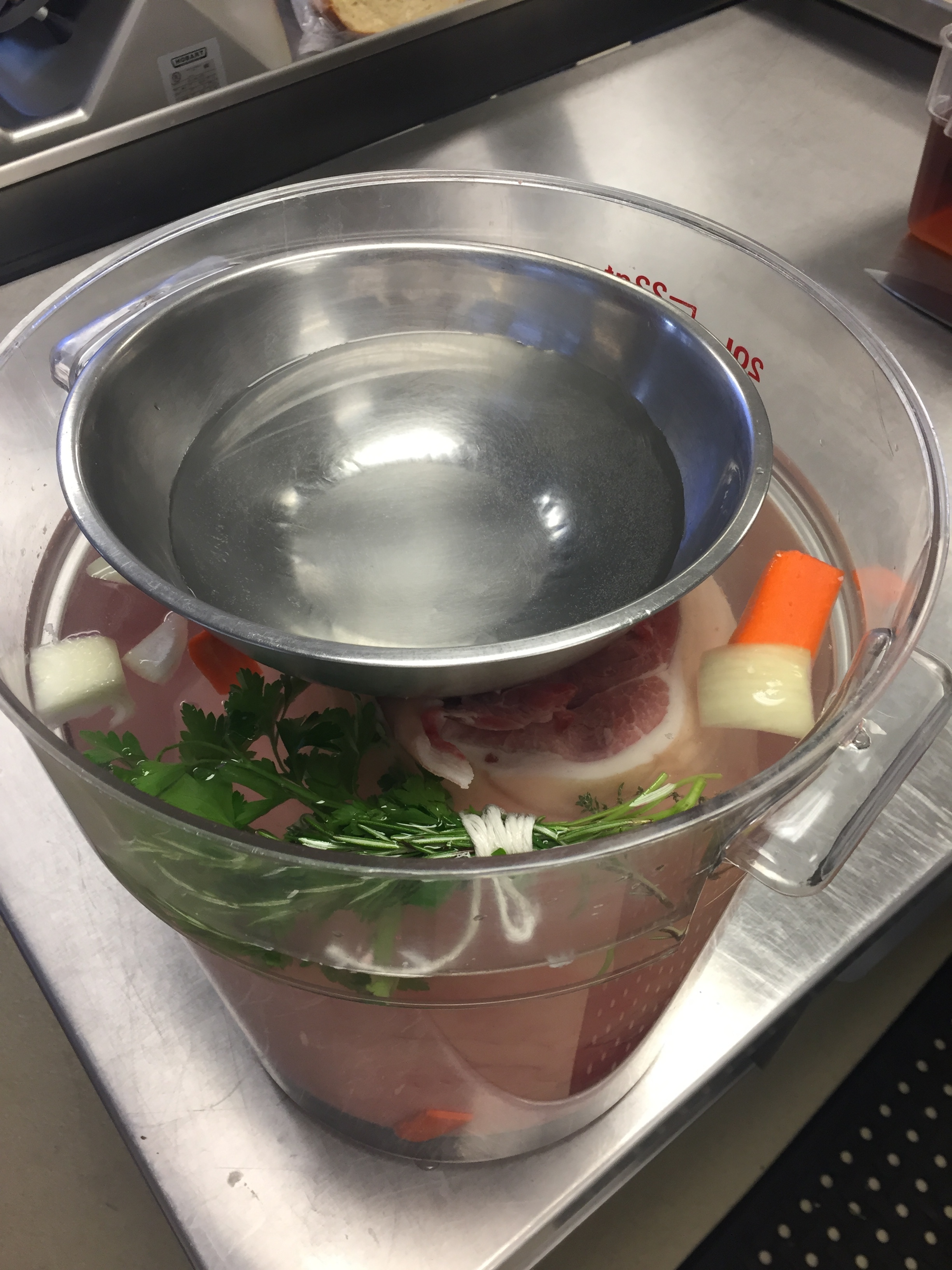 Placing a bowl on top of a ham to keep it submerged in the brine