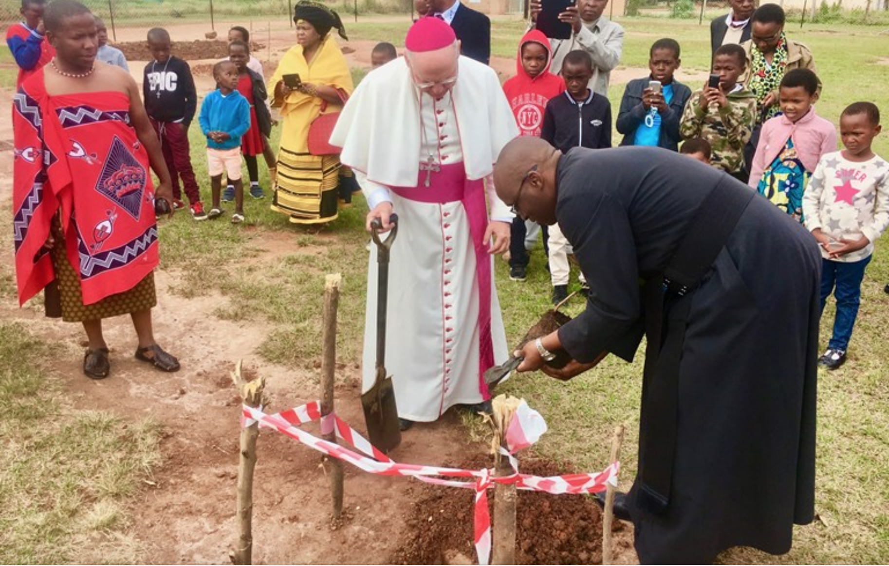 Archbishop Peter Wells, the Apostolic Nunciature of South Africa, practicing deed over deity by helping to plant trees in a village outside Johannesburg.SOURCE COURTESY OF ARCHBISHOP PETER WELLS