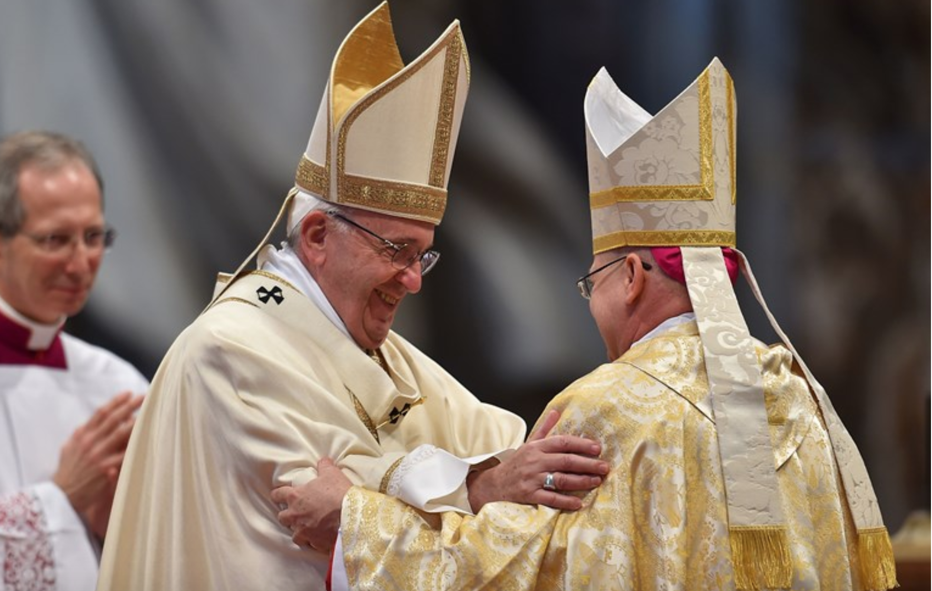 Pope Francis (left) congratulates newly elevated bishop, Peter Bryan Wells, during his ordination on March 19, 2016, at St. Peter’s Basilica in the Vatican.SOURCE VINCENZO PINTO/AFP/GETTY IMAGES