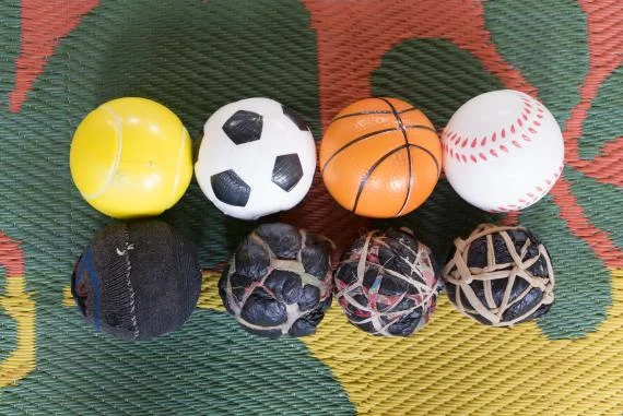 Sponge balls made by parents and children next to a set of UNICEF’s bouncy balls. Balls encourage movement, muscle strengthening and dexterity among children.