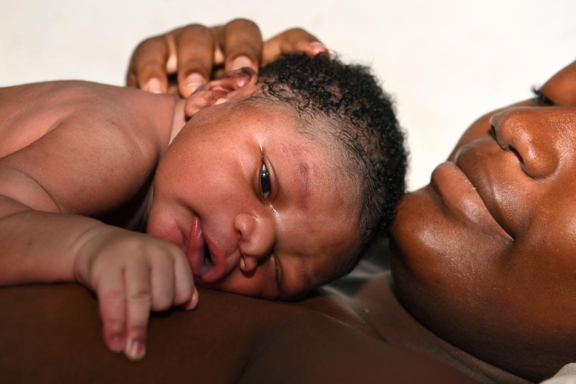 Abidjan, Côte d’Ivoire, 12:11 am: Aicha Koné rests with her minutes-old son, 4.5 kg (9.9 lbs.), at Hôpital de Port-Bouët. “He’s really a big boy,” Aicha says, “and I hope he will be strong and have a healthy life.” The Government of Côte d’Ivoire joined the Scaling Up Nutrition movement in 2011, and UNICEF now works with civil society groups to increase nutrition interventions and to promote breastfeeding for the first six months.