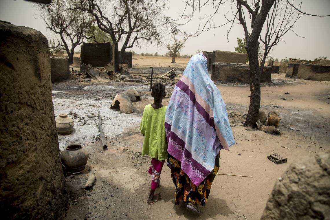 Maïmouna Barry, 45, walks through what is left of the village of Ogossagou-Peulh, Mali, on 2 April 2019 with her daughter Hawa, 10. Less than two weeks before, Maïmouna lost her youngest daughter during an attack on the village, which left more than 150 people dead, one-third of whom were children. With the help of UNICEF, community learning centres are being set up across the central Sahel region, as safe spaces for children to study, play and receive psychosocial support.