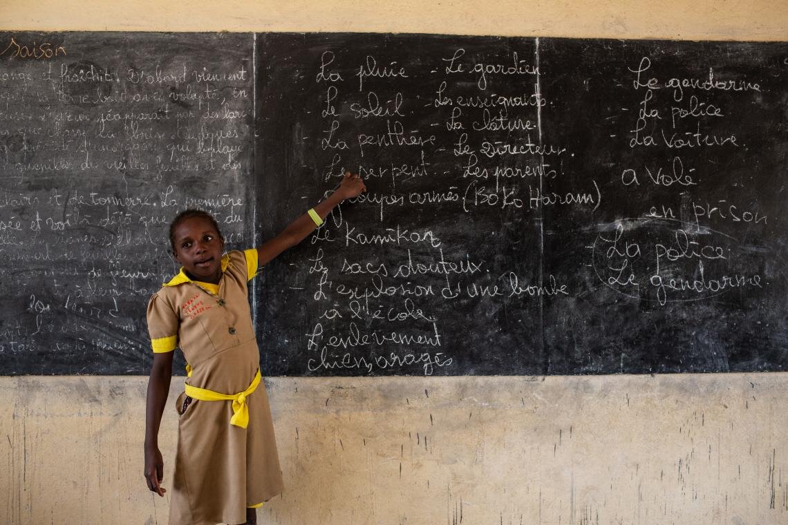 A student goes over blackboard notes on emergency preparedness at a school in Baigaï, a village in Cameroon near the border with Nigeria on 26 May 2019. The programme focusses on teaching children and teachers how to mitigate an armed attack. Despite the risks, people on the front lines of this struggle will not rest until children in their communities are guaranteed the education that is every child’s right.