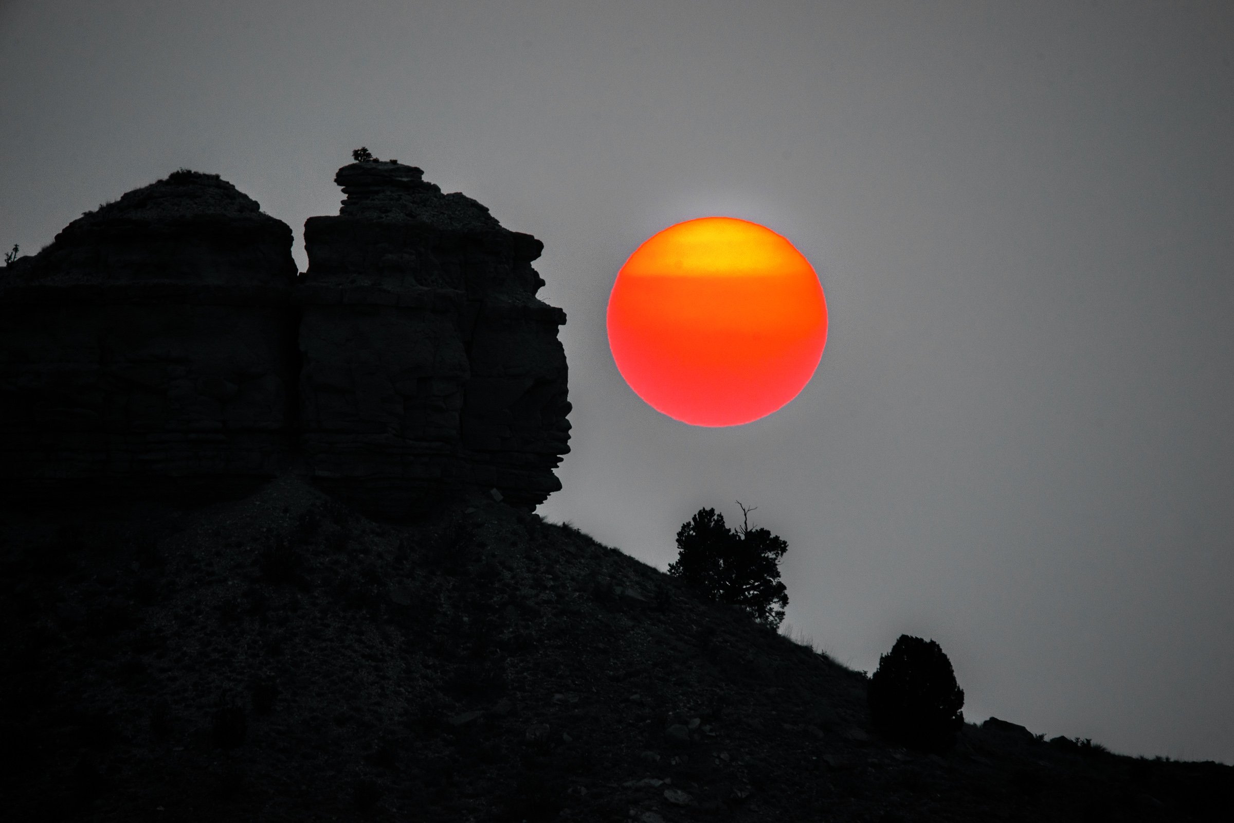 Smoky Red Sun and Bluffs