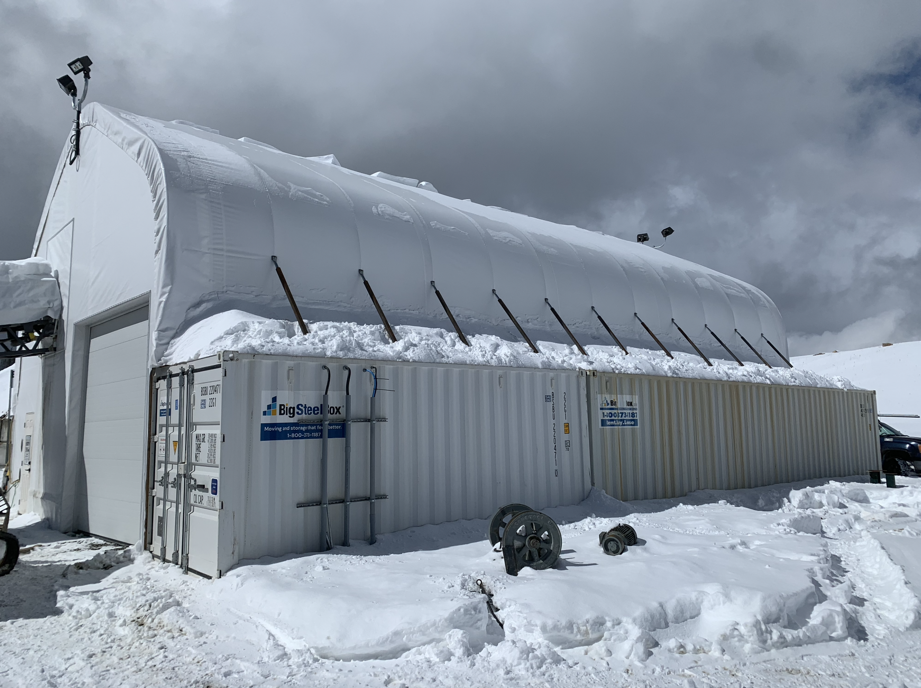 Large custom cover all building with snow on cloudy day