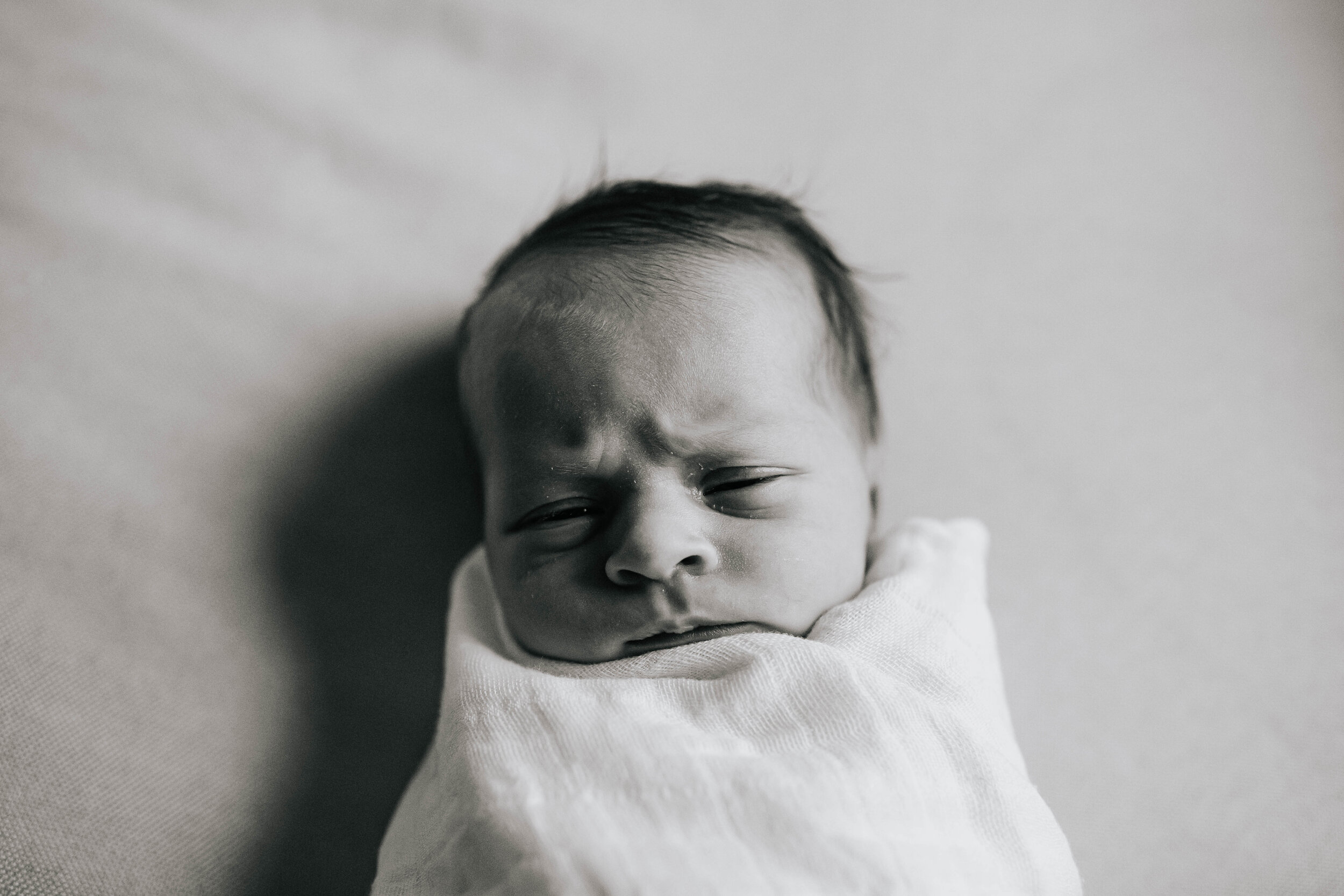 Newborn making sleepy face