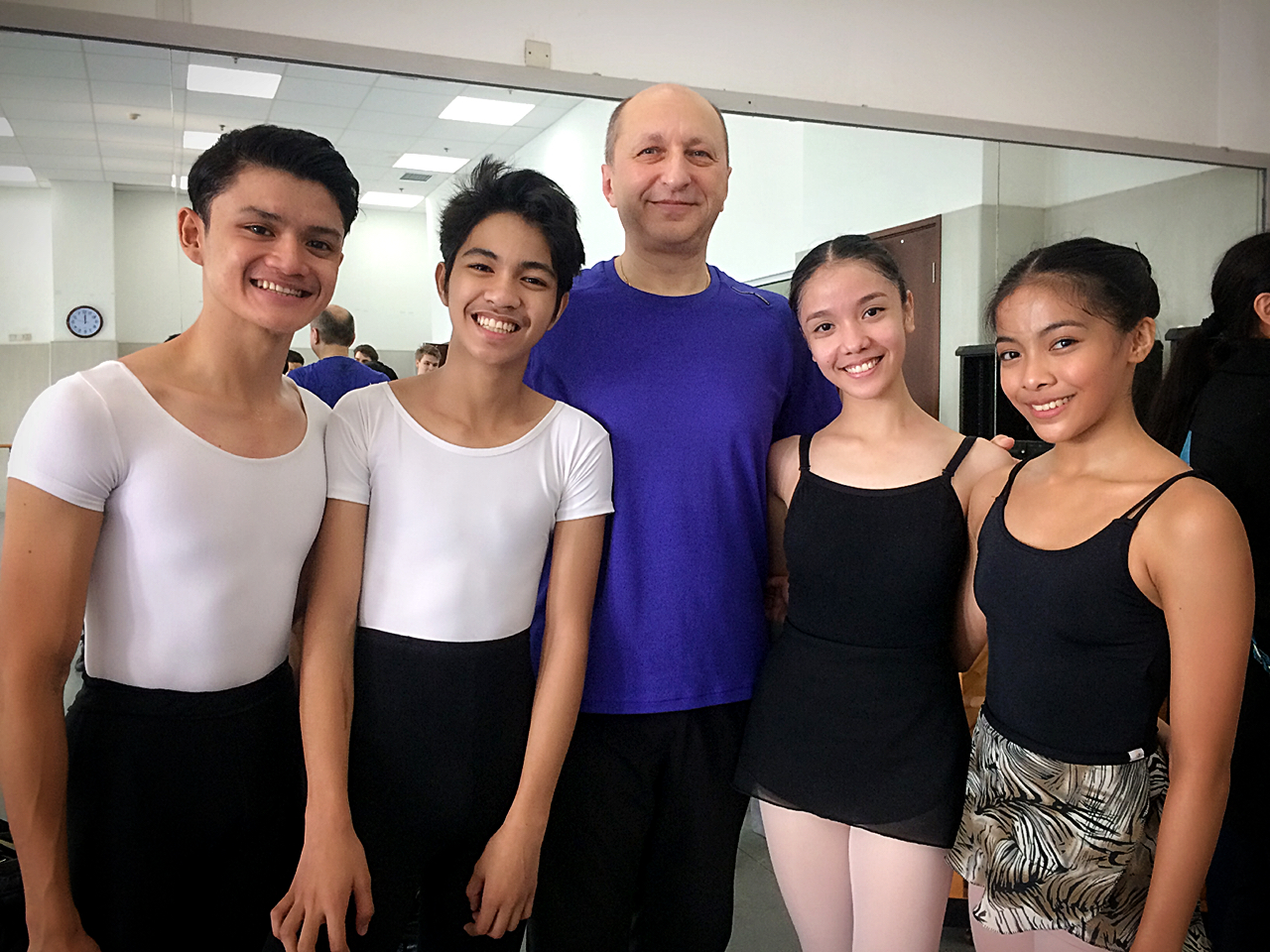 The dancers pose with Eldar Aliev, master choreographer of the Mariinsky Ballet, after taking Vaganova Ballet Technique class with him. Photo courtesy of Gerardo Francisco
