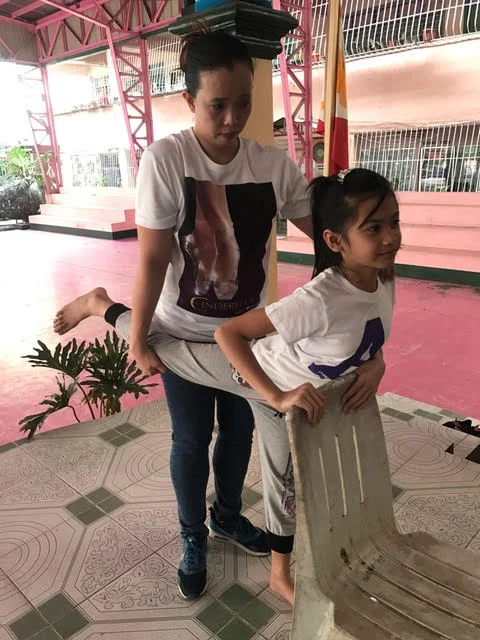 Ballet Manila rehearsal mistress Eileen Lopez checks a student’s flexibility during one of the auditions for Project Ballet Futures scholars.