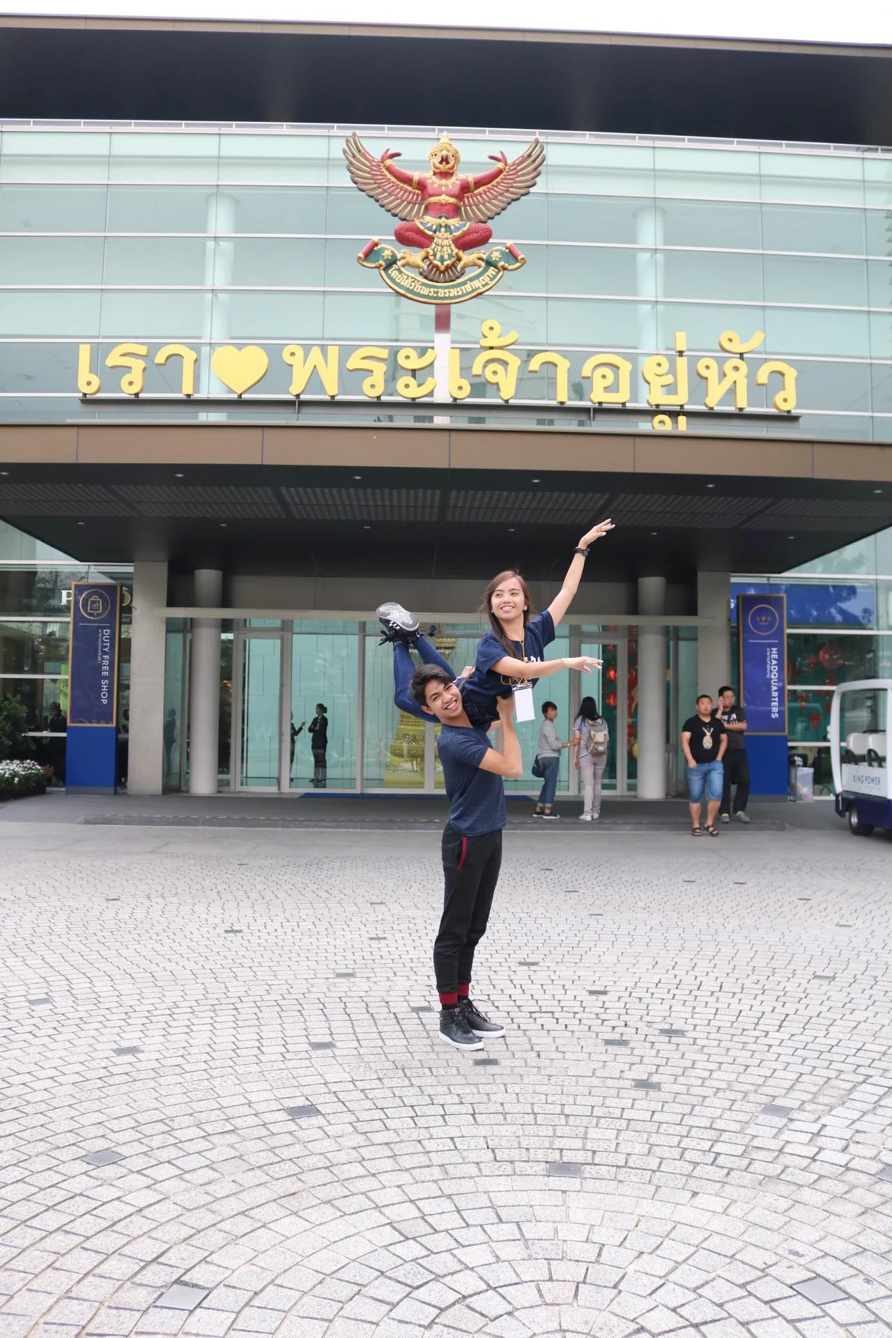 Alvin Dictado and Elyssabeth Apilado demonstrate a shoulder lift outside the AKSRA Theater, the competition venue, on registration day.