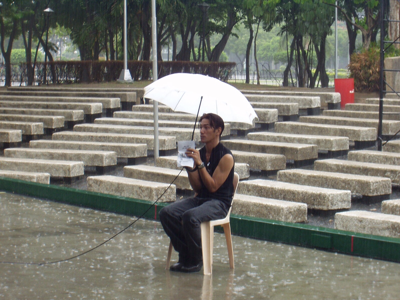 The show must go on! Shaz sits in the rain as he conducts rehearsals for a Ballet Manila engagement at the Rizal Park Open-Air Auditorium. Photo by Jimmy Villanueva