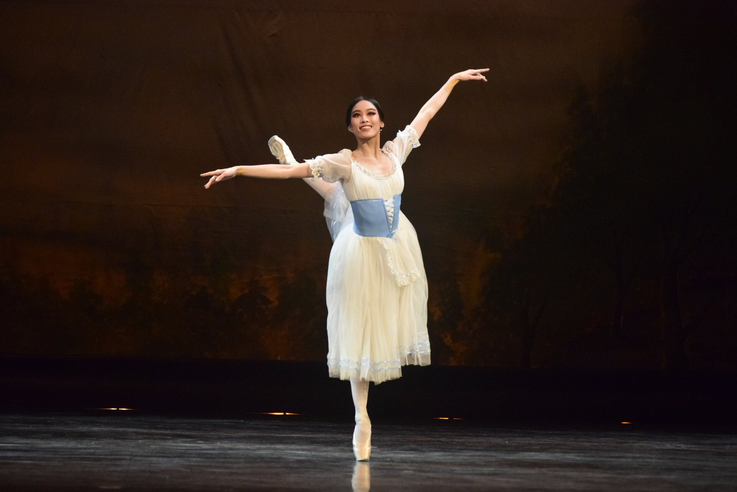   Giselle (Joan Emery Sia) wears a dainty white dress with eye-catching accents in delicate blue in Act 1 of  Giselle , 2019. Photo by Erickson Dela Cruz  