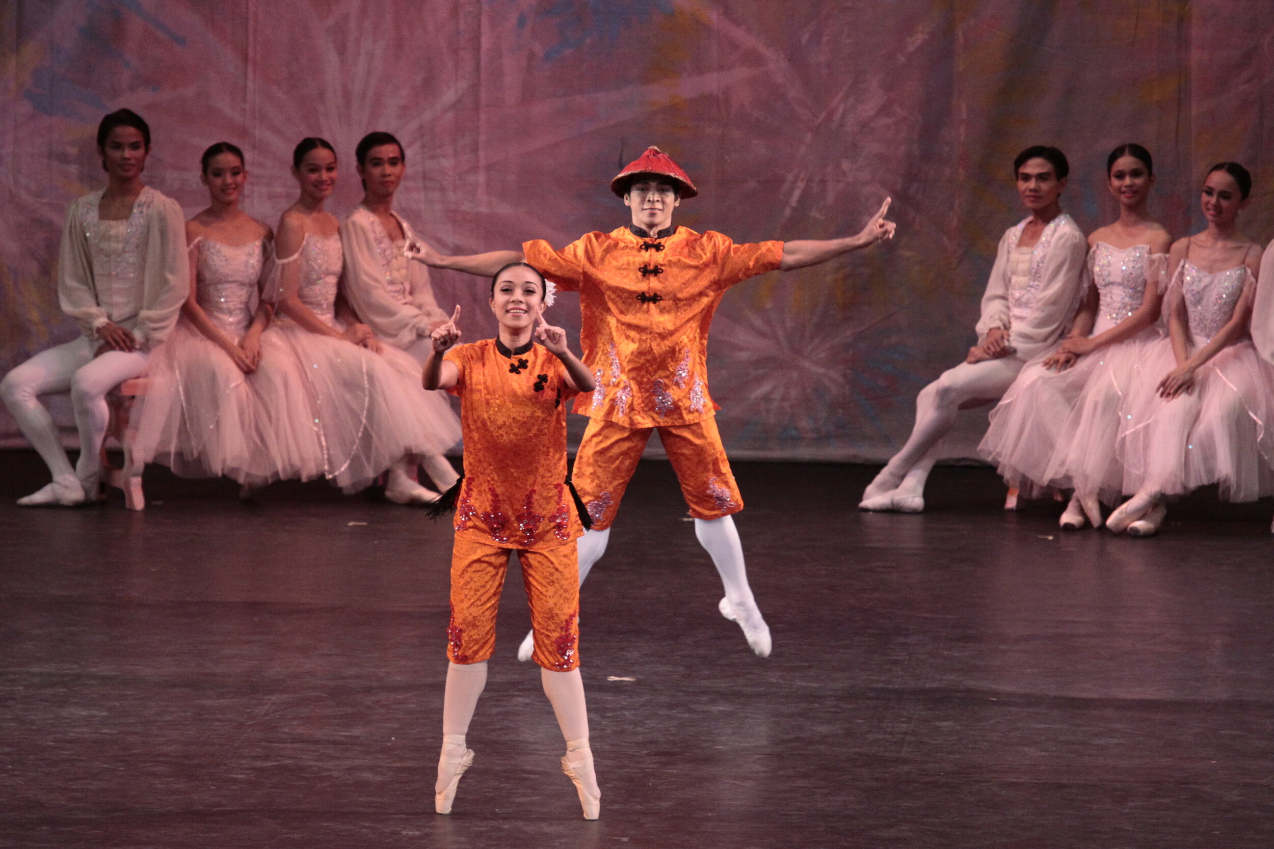    Again cast for the Chinese dance in  The Nutcracker  in 2010, Gerardo Francisco this time partners Mylene Aggabao. Their tunic costumes are the same, still a dazzling orange made even more shimmery with touches of sequins. Photo by Ocs Alvarez   