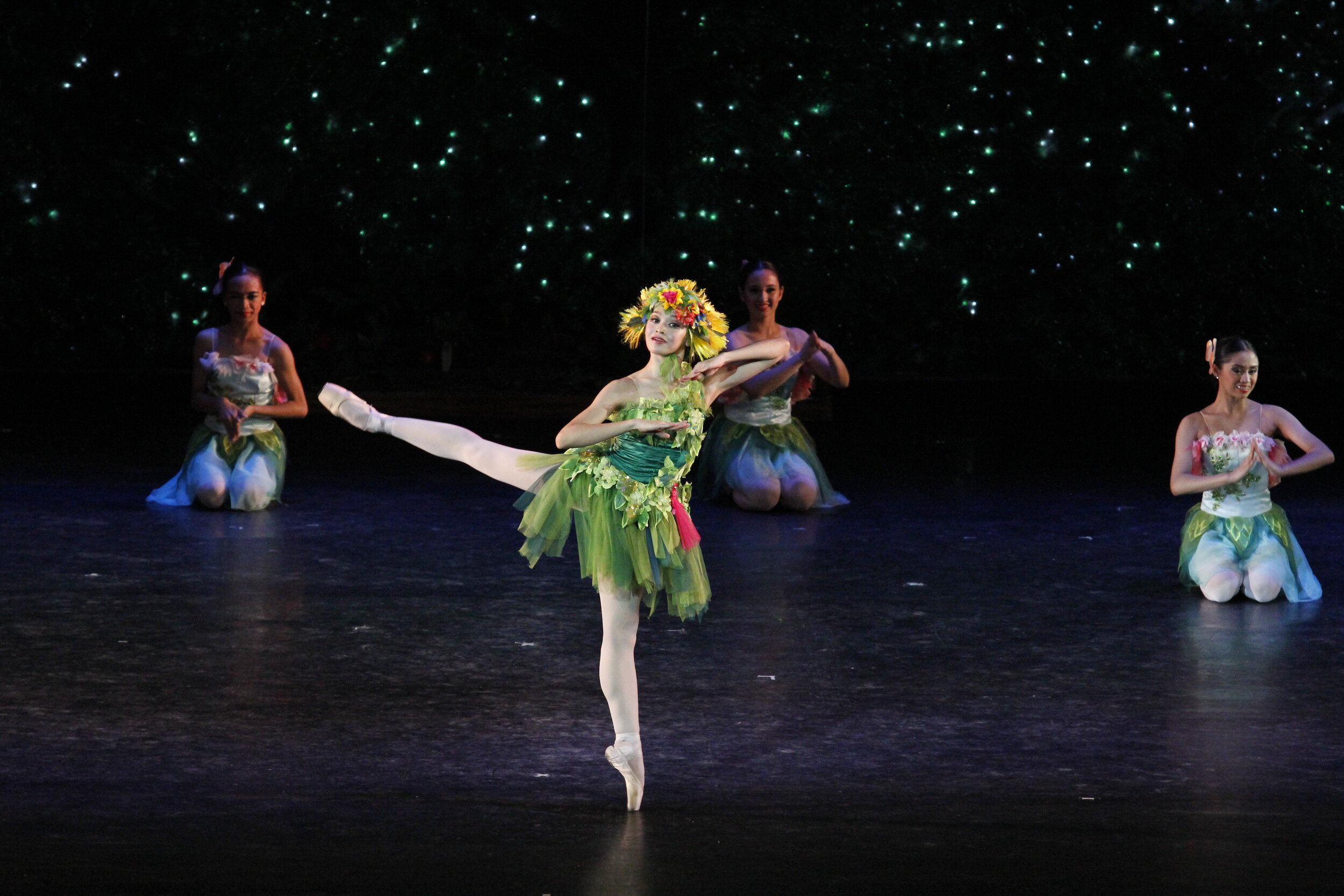    The mystical being Tiera (Dawna Reign Mangahas) channels the environment in a tutu spanning the shades from lime to emerald, as Garden Spirits wear complementing colors. The scene is from  Sinderela , a modern version of the classic fairy tale cho