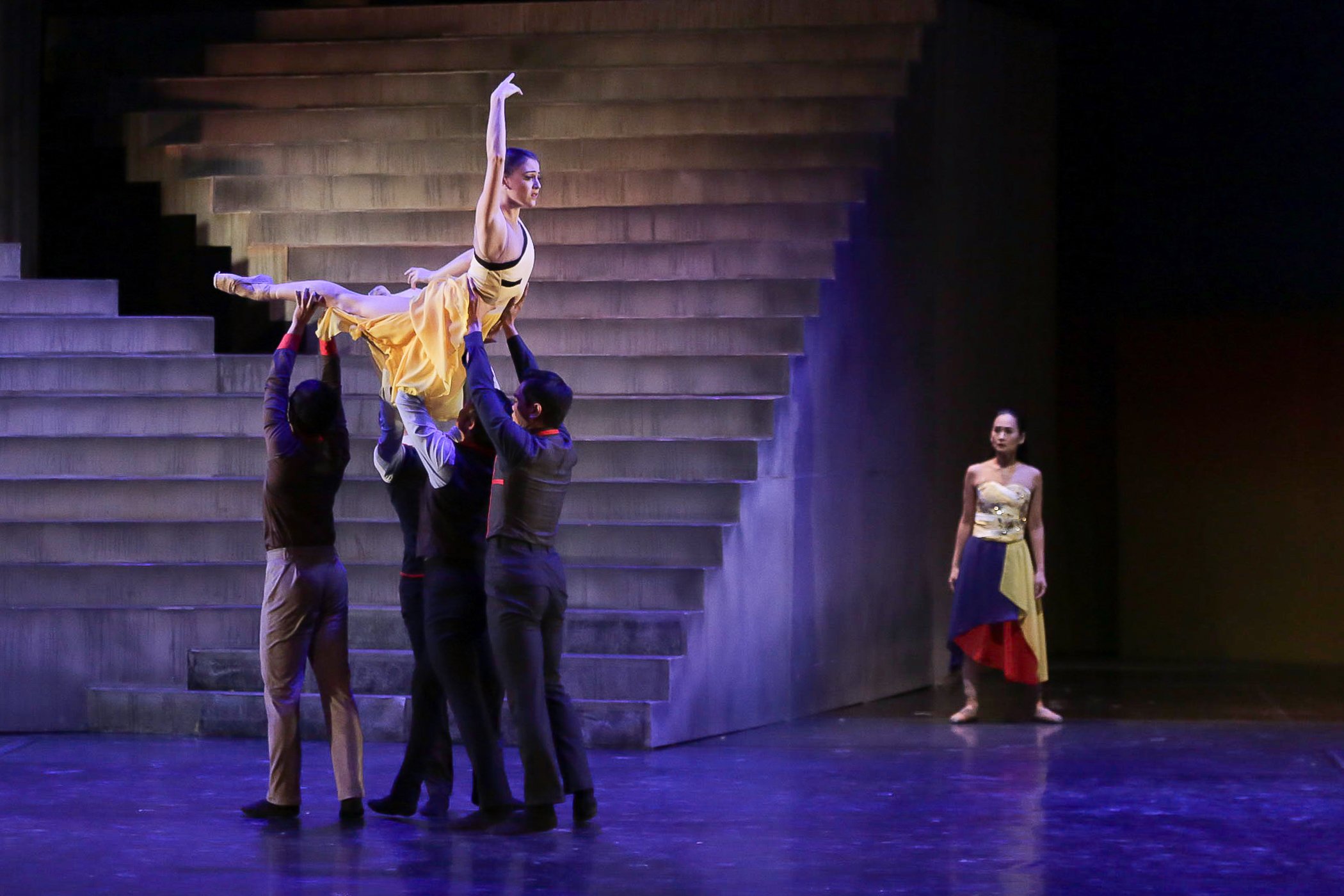    Katherine Barkman soars, literally, in this scene from Martin Lawrance’s  Rebel  where she was cast as Corazon, with Lisa Macuja-Elizalde as Inang Bayan. Aside from the People Power Revolution and Spartacus mash-up, Katherine made her full-length 