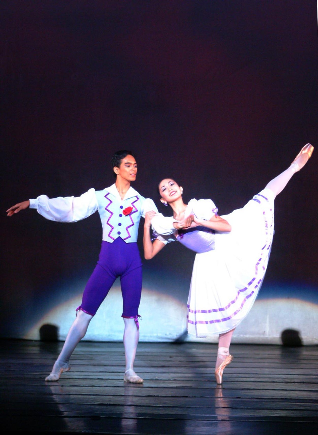    Ricardo Mallari and Marian Faustino make a purple pair in August Bournonville’s  Kermesse in Bruges  pas de deux. The duo performed the piece in  OPM at OPB  (2003) shortly after dancing it as participants in the New York International Ballet Comp