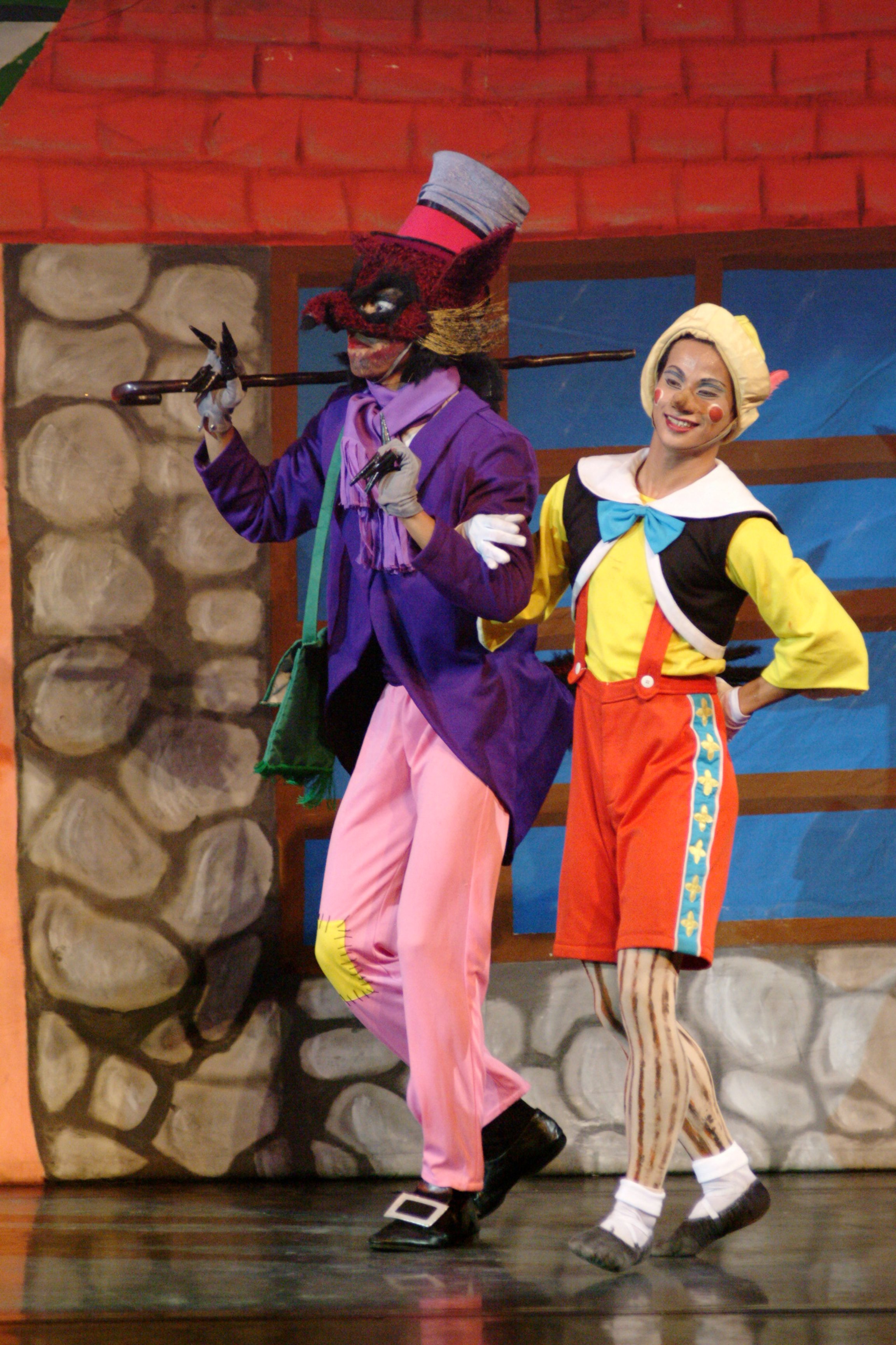    Osias Barroso’s  Pinocchio  (2004) is a jumble of colors as exemplified by this scene showing the lead character, the puppet Pinocchio (Alvin Santos) and the Fox (Francis Cascaño), the latter wearing a deep purple coat, a violet scarf and pink pan