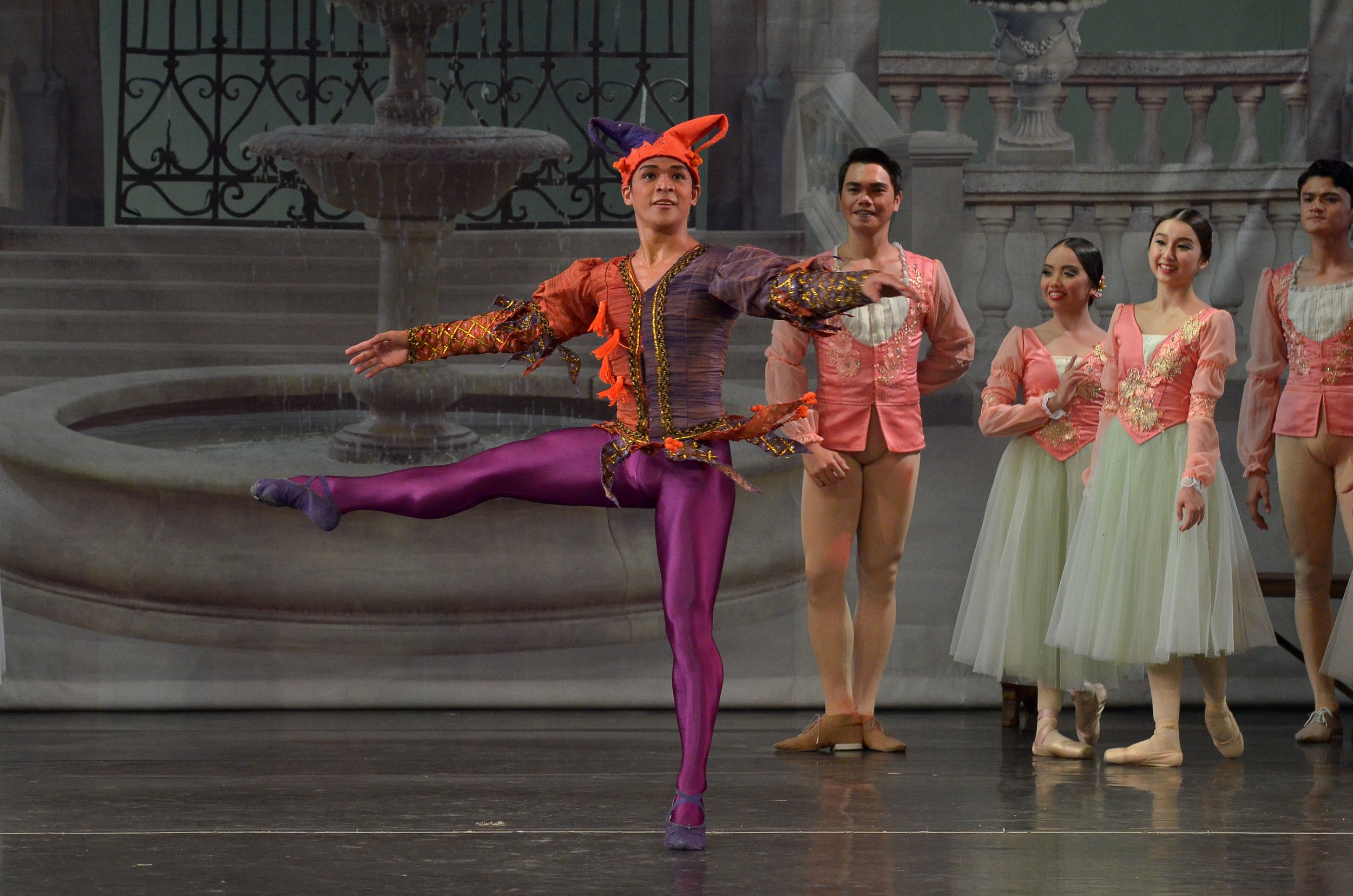    As the Jester in  Swan Lake  (2017), Gerardo Francisco draws attention not just with his antics but his get-up which is in a combination of attractive colors, including wine-colored tights and a pair of purple shoes. Photo by Ocs Alvarez   