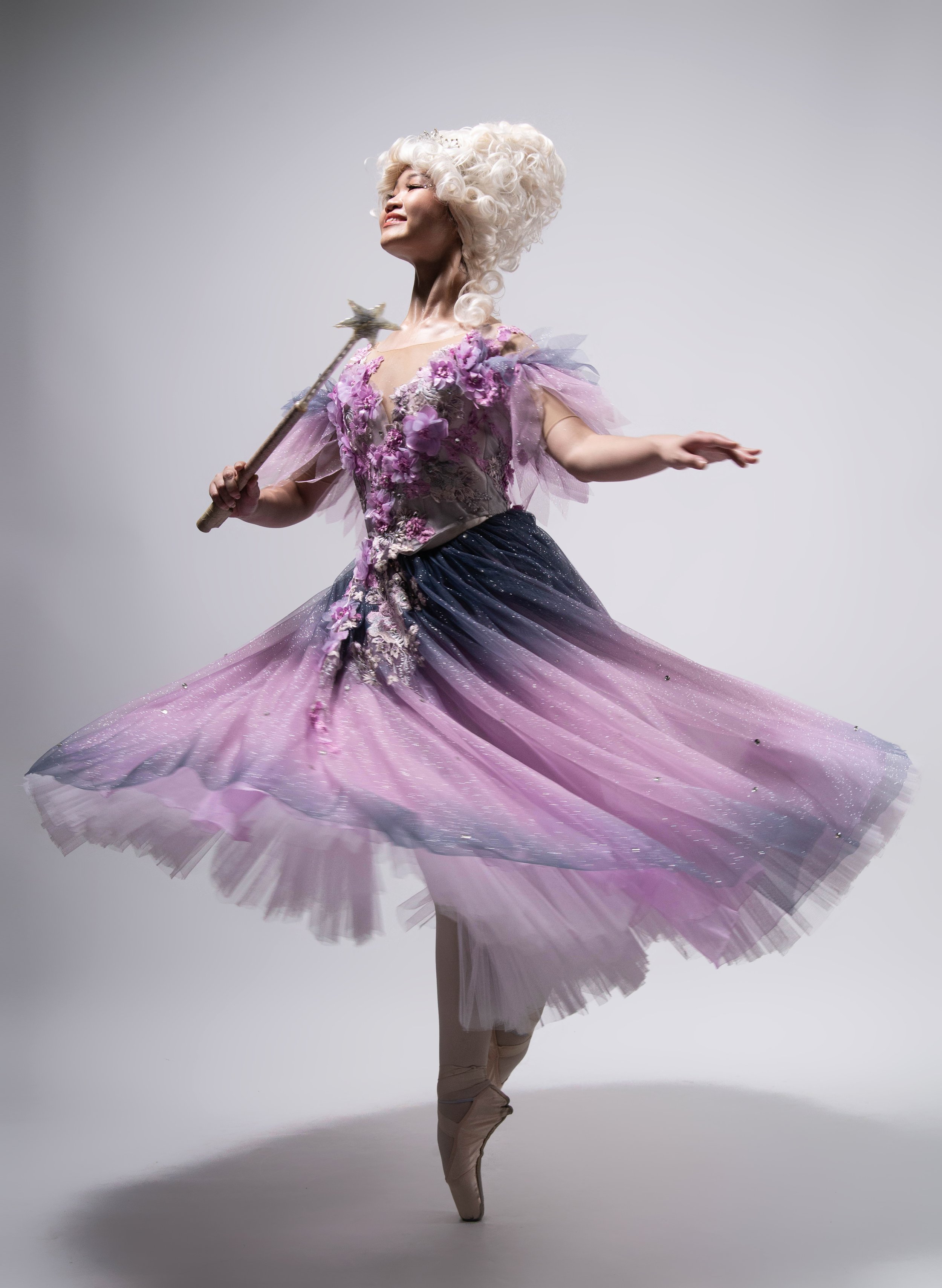    Kong Ke Xin as Fairy Godmother makes magic with a wave of her wand and a twirl of her tutu in shades of lavender and lilac in Lisa Macuja’s  Cinderella  (2018). Photo by MarBi Photography   