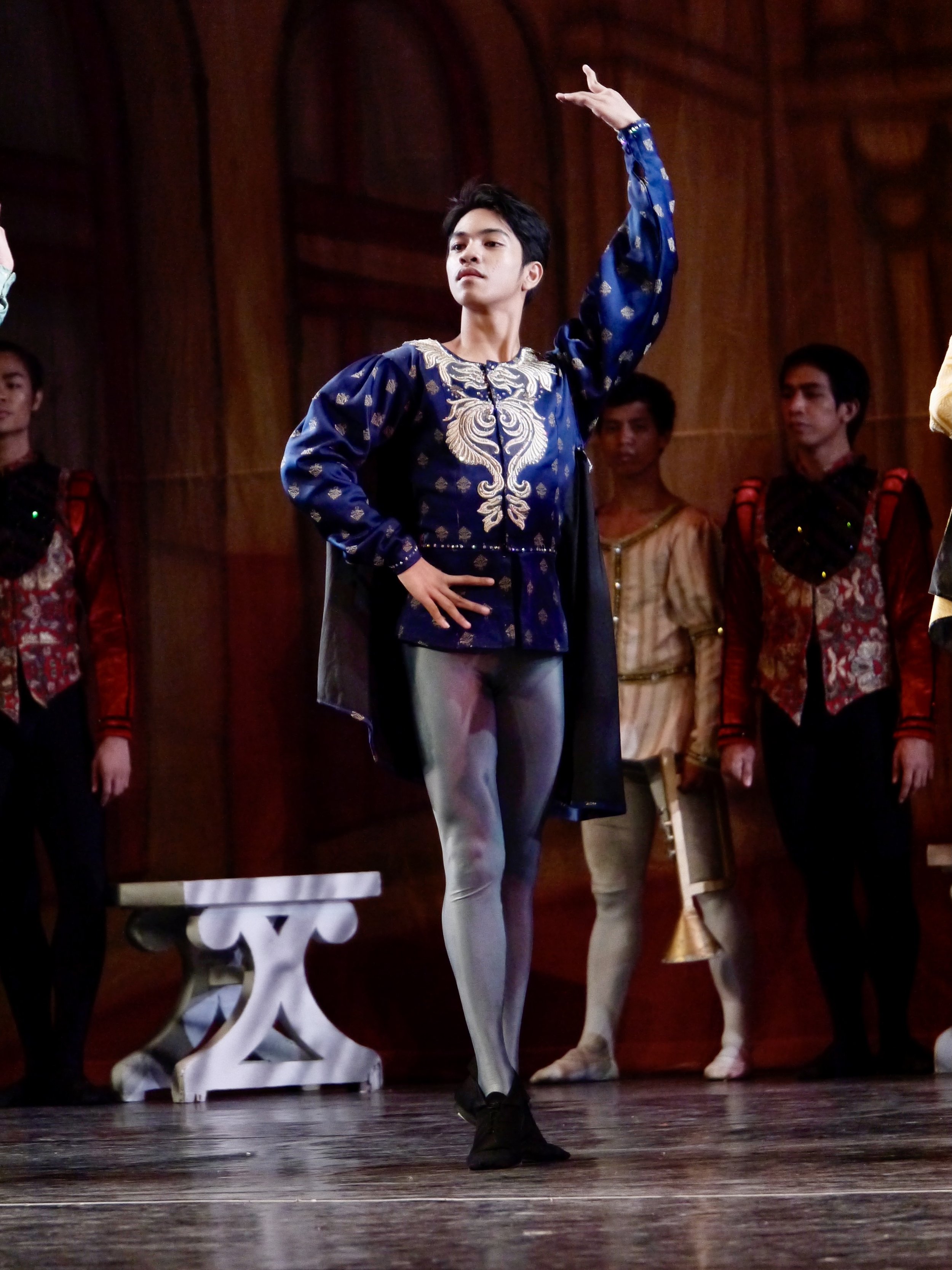   As one of the aristocrats attending the birthday celebration of Prince Siegfried in  Swan Lake  (2017), Alvin Dictado puts on a coat of blue with gold details paired with gray tights. Photo by Giselle P. Kasilag   