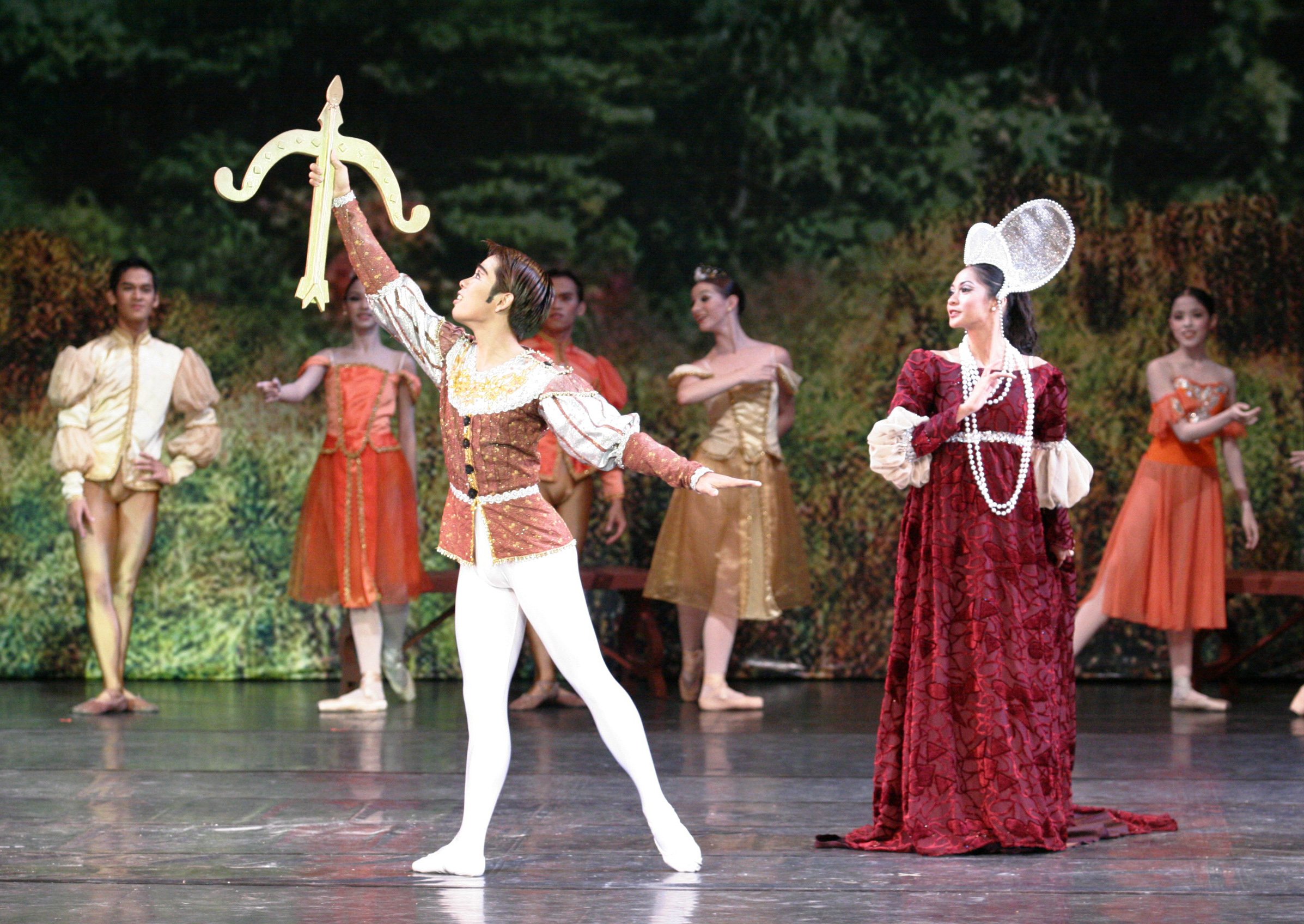    Christine Rocas, doting mother to the carefree Prince Siegfried (Jonathan Janolo) in  Swan Lake  (2005), is resplendent in a maroon gown in rich velvet with puff details on the sleeves and a glittery empire-cut trim. Pearl strands, pearl earrings 