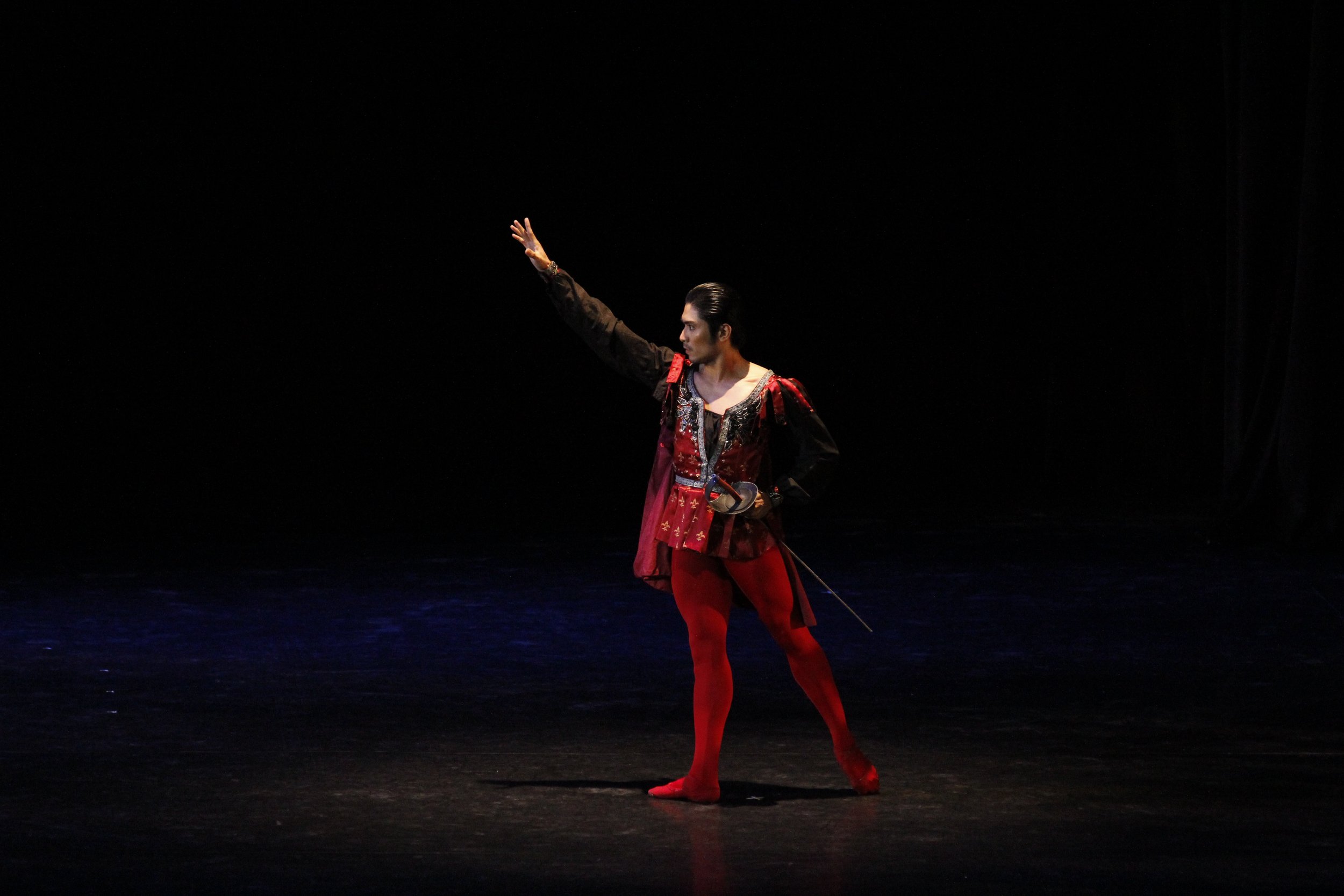    Red stands for courage, and this Mercutio (Romeo Peralta) has in spades, as he is set to confront Romeo who is rumored to be courting his cousin Juliet in Sergey Vikulov’s  Romeo and Juliet , excerpted in  Gold  (2014). Photo by Ocs Alvarez   