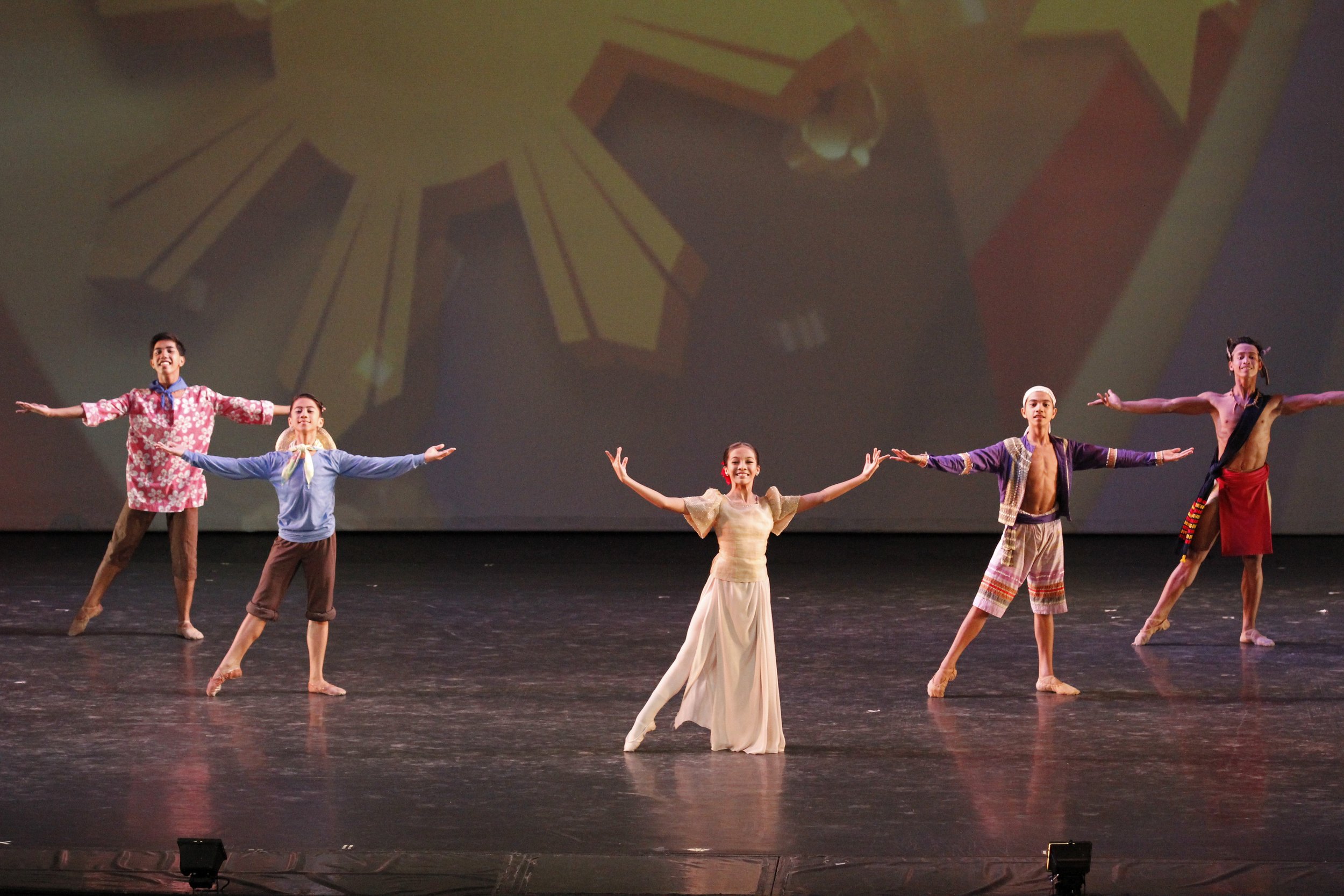    In her cream-and-beige Filipiniana attire, Nicole Barroso leads fellow Ballet Manila School scholars and Project Ballet Futures scholars in the rousing kick-off to the production  Kay Ganda ng Ating Musika  (2014). The opening number, choreographe