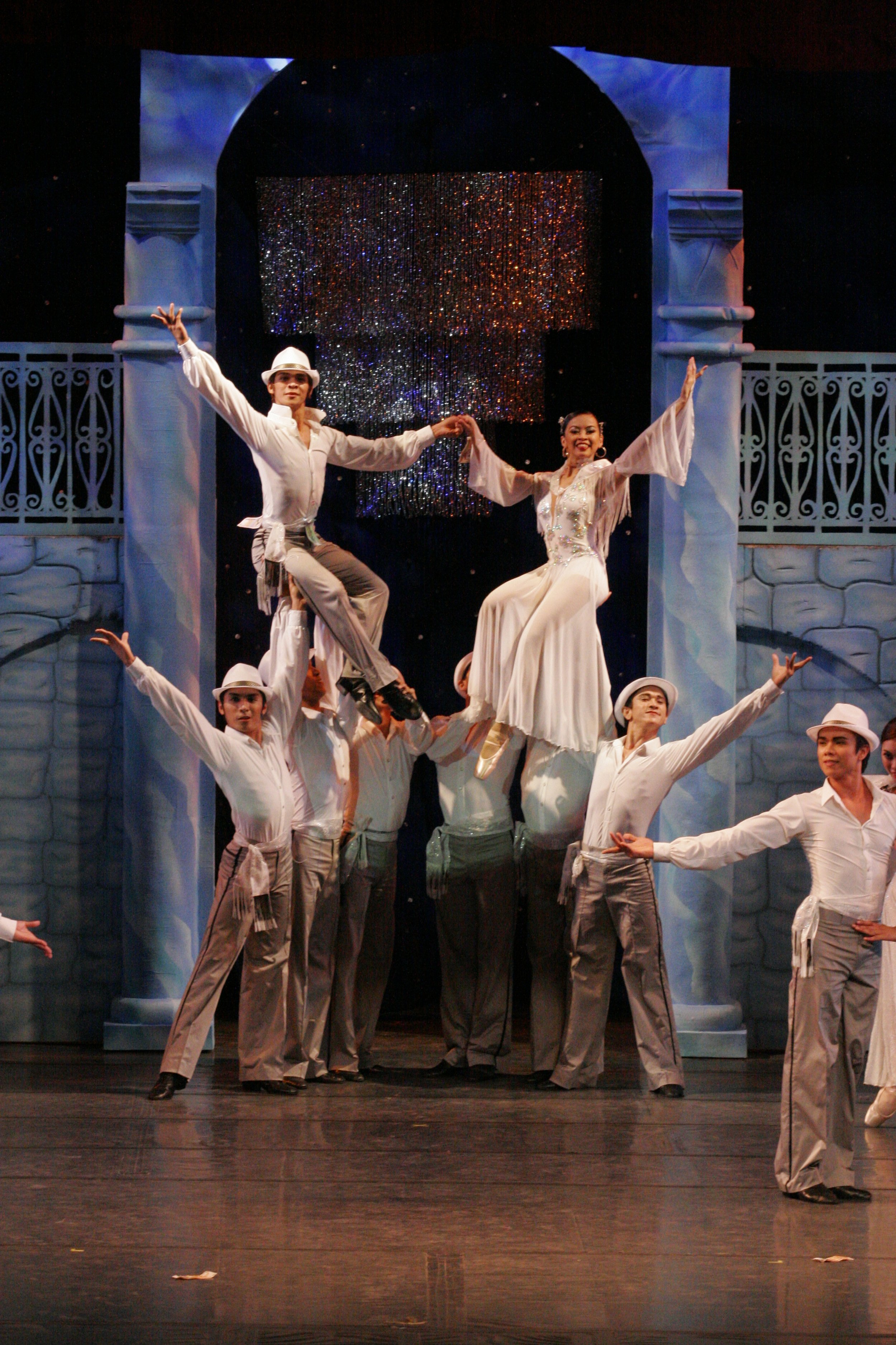    The gray-and-white color combination worn by the groom (Gerardo Francisco Jr.) is echoed in the outfits of the male entourage as they carry him and his bride (Sofia Sangco-Peralta) aloft in  Dulce . The rousing ballroom-to-ballet number was choreo