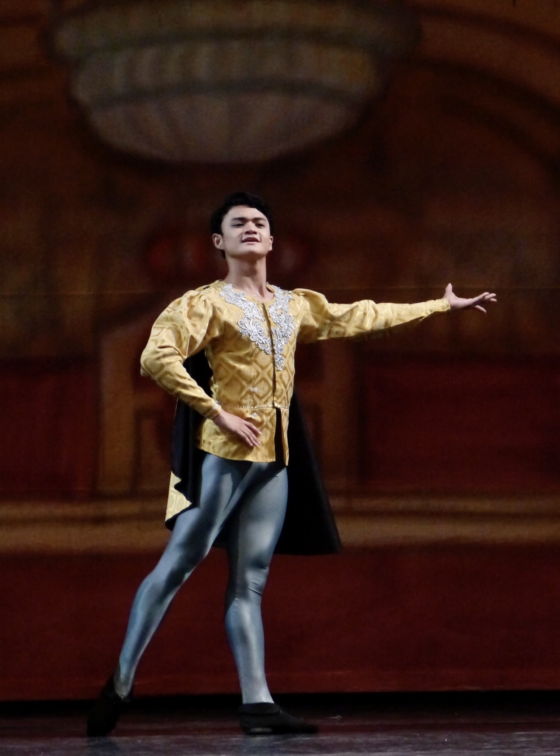    Joshua Enciso is debonaire in yellow coat and gray tights, performing as one of Prince Siegfried’s friends attending the royal’s 21st birthday ball in  Swan Lake  (2017). Photo by Giselle P. Kasilag   