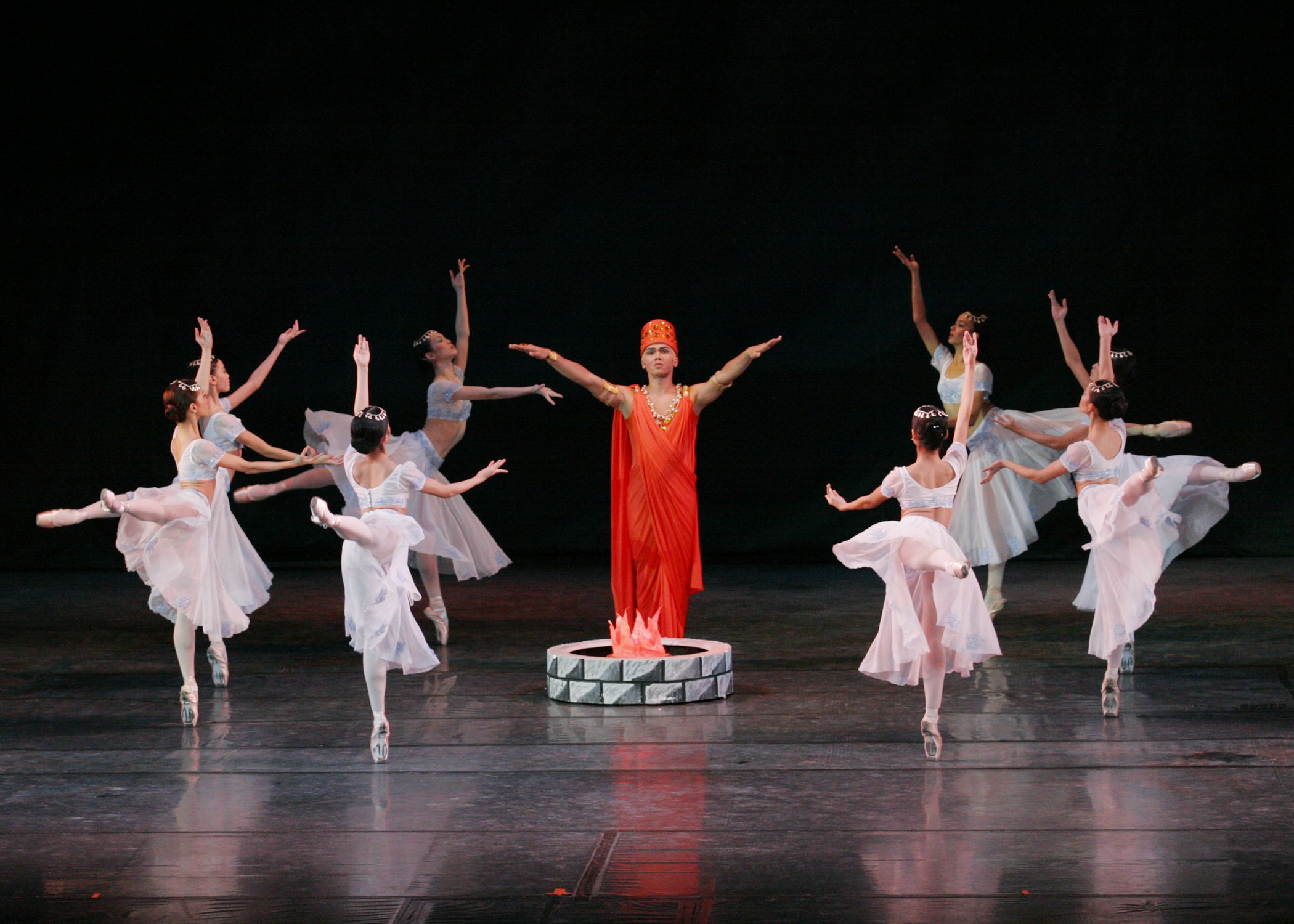    Clad in bright orange robes and exuding authority, the High Brahmin (Marcus Tolentino) commands attention in  La Bayadere  (2004). He is a standout among the bevy of temple dancers wearing white as they worship the sacred fire, but he only has eye