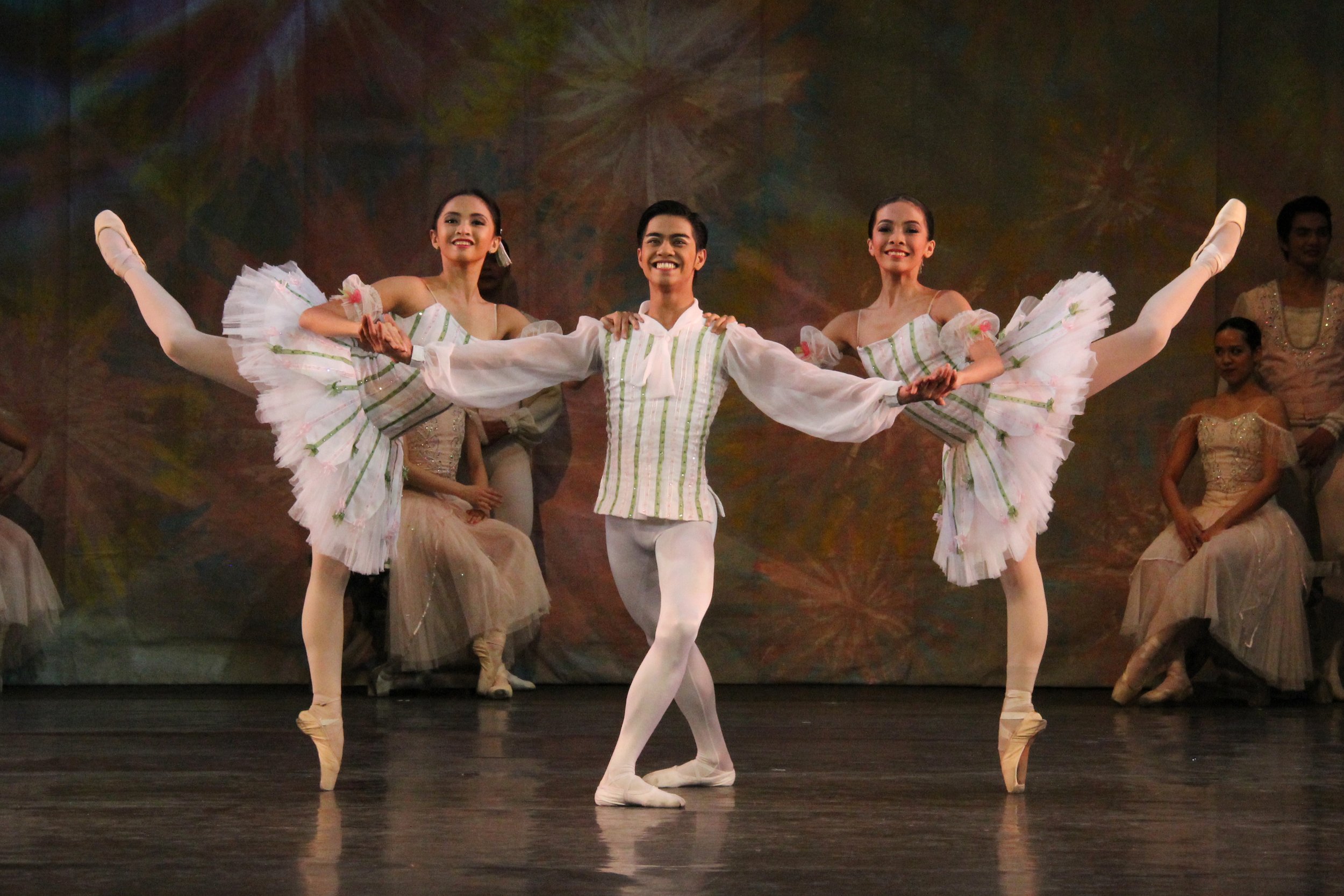    The trio of (from left) Shayne Cerdan, Anselmo Dictado and Nicole Barroso flash toothy grins to match the glistening whiteness of their costumes with green stripe accents in  The Nutcracker,  as excerpted in  Nutkraker  (2014). The Reed Flutes is 