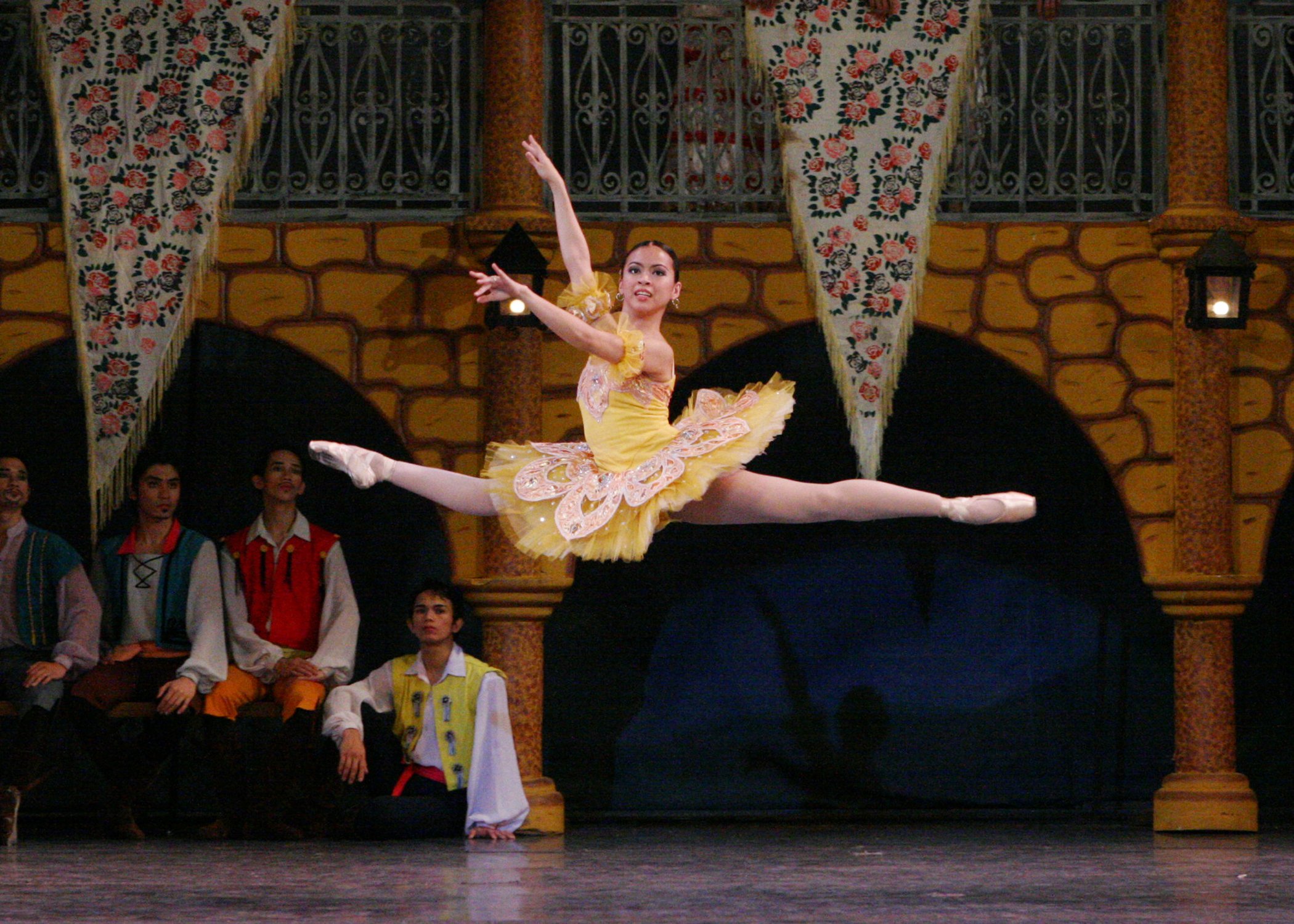   Don Quixote  is renowned for vigorous dancing. In Ballet Manila’s 2006 staging, Sofia Sangco-Peralta – as one of Kitri’s bridesmaids – gets in the spirit of things as she makes a joyous leap in a yellow tutu at her friend’s wedding to Basilio. Phot
