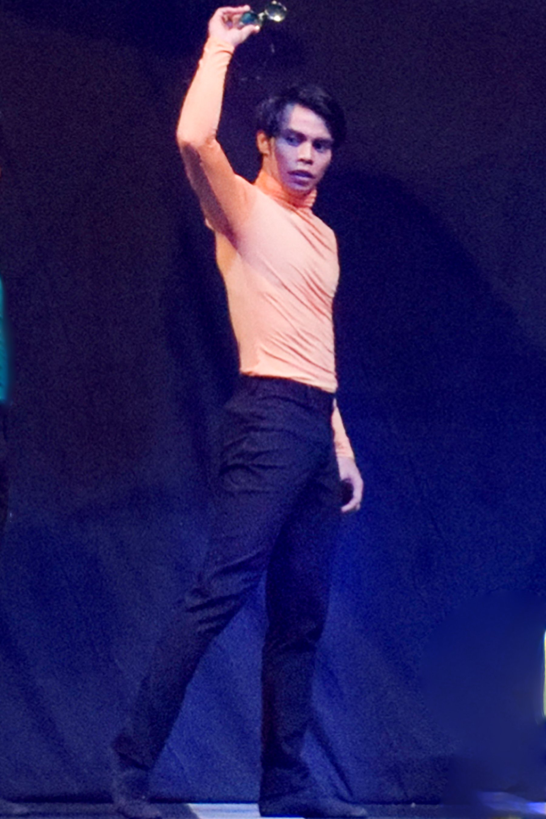    John Balagot channels a groovy vibe in this orange turtleneck top and those shades he has just taken off in keeping with the music used in  The Winding Road . Choreographed by Martin Lawrance to a medley of songs by The Beatles, the work premiered