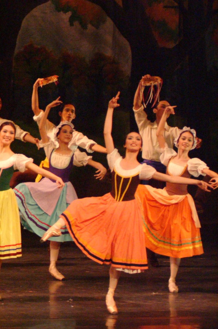   The village girls in  Giselle  (2005) go for happy colors, including peach and orange for the two at the right, as the town engages in merriment as Giselle and Albrecht fall giddily in love with each other. Photo by Ocs Alvarez   