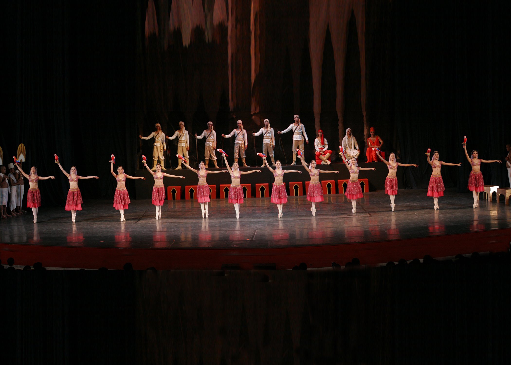    Red in a row! The girls in the Parrot Dance of  La Bayadere  (2004) wear the same color as the plumes of the bird they’re each holding. Photo by Ocs Alvarez   