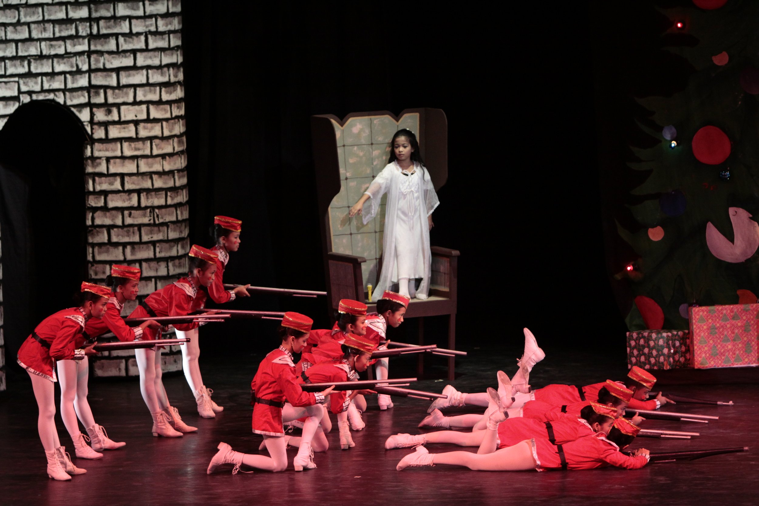  &nbsp;  Clara (Nicole Barroso) looks on in awe as an army of toy soldiers – in red uniforms and caps – springs to life in her dream, as presented in the Christmas favorite,  The Nutcracker  (2010). In the story, they come to the assistance of the Nu