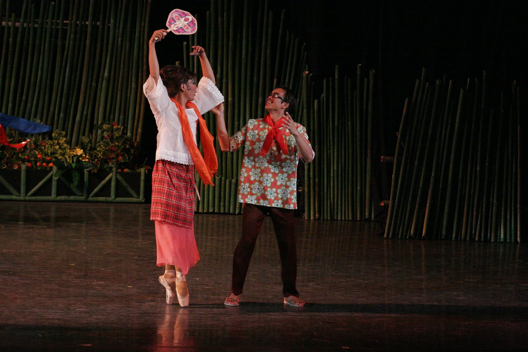    Waving a native fan while twirling about, Jonathan Janolo (left) is the coquette who tries to catch the attention of Marcus Tolentino’s barrio gent – and succeeds – in  Pista , a joint choreography of Osias Barroso Jr. and Gerardo Francisco Jr. wh