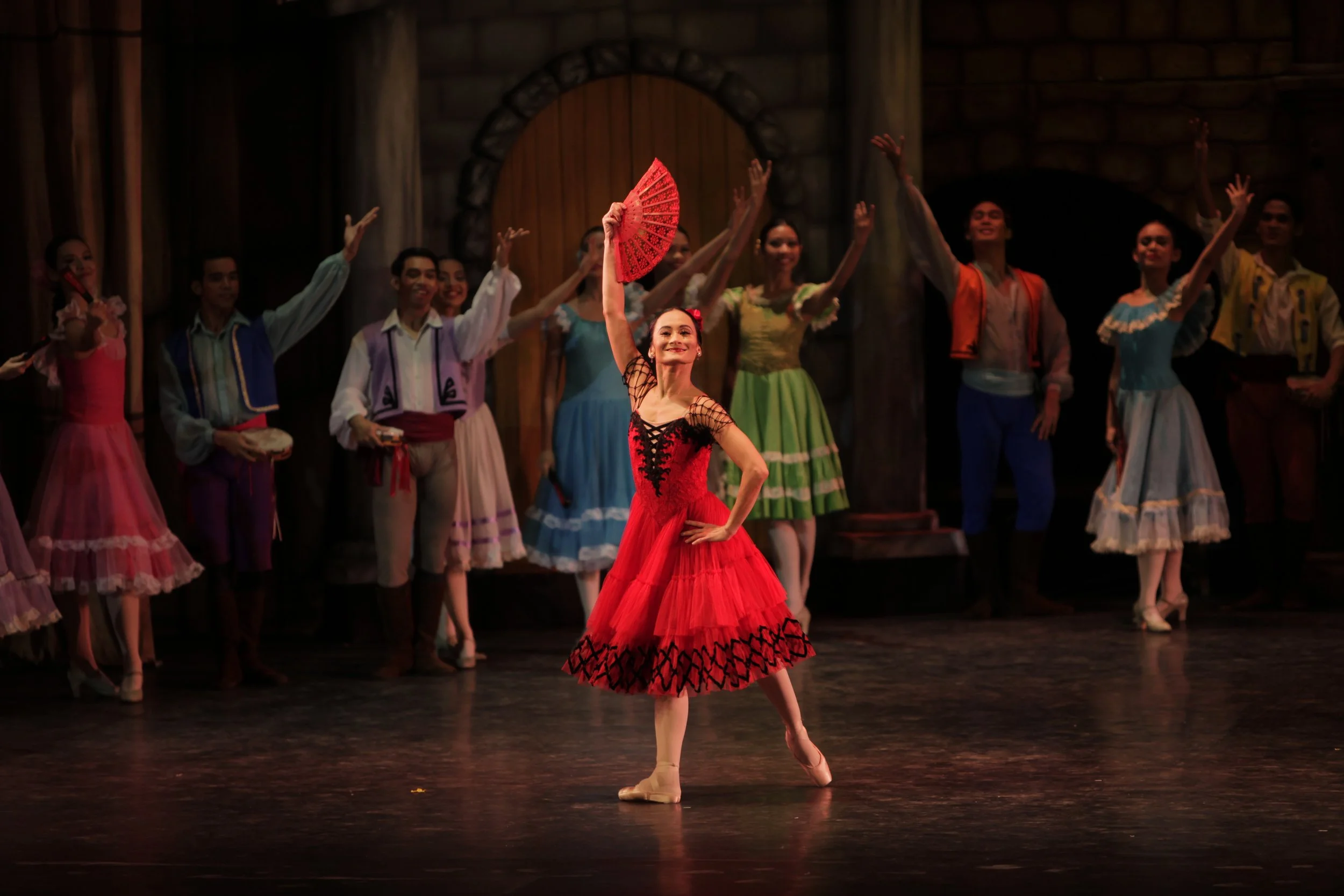    The playful nature of Kitri (Lisa Macuja Elizalde) shines through as she moves her fan in a rapid and festive mode on her way to meet Basilio in this scene from  Don Quixote  (2012), part of the prima ballerina’s  Swan Song Series  in which she sa