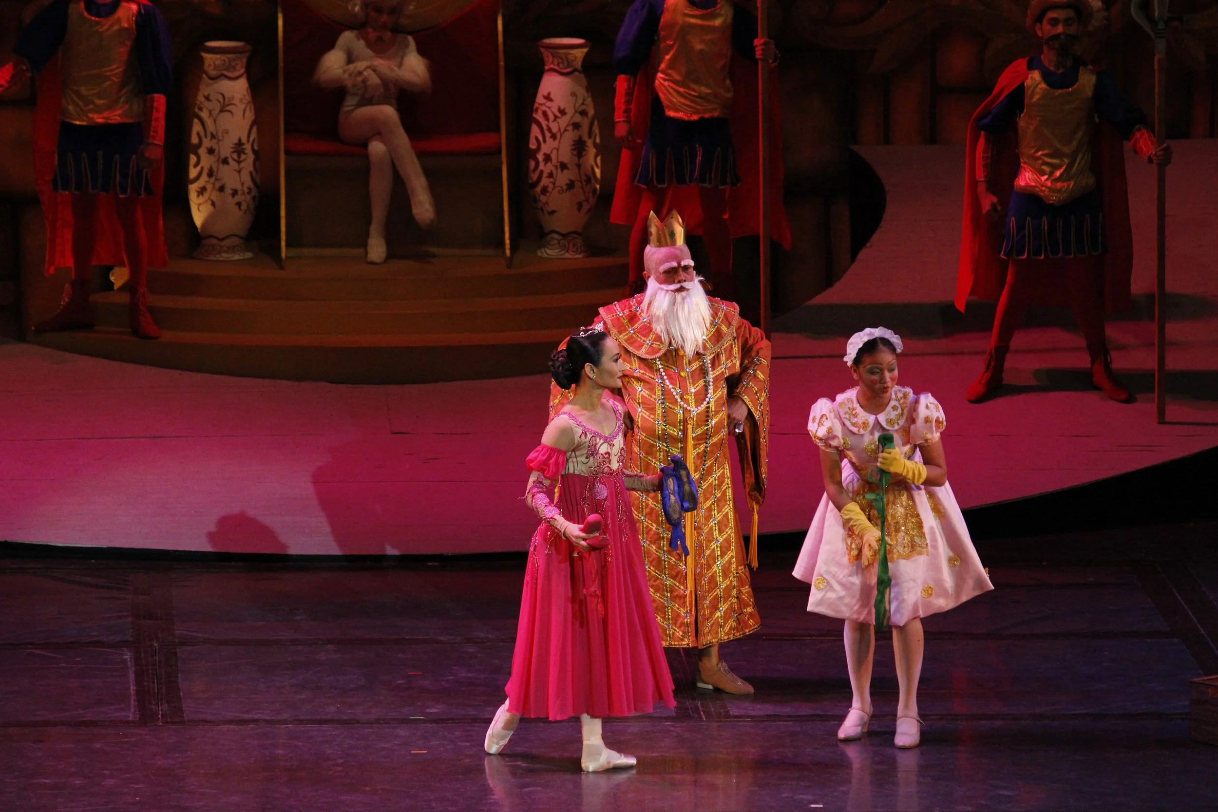    Baffled as to why his twelve daughters’ shoes are muddied every morning, The King (Marcus Tolentino, center) orders the Servant Girl (Justine Kaye Pitahin, right) to summon the Eldest Princess (Lisa Macuja Elizalde, left) to explain. Unable to giv