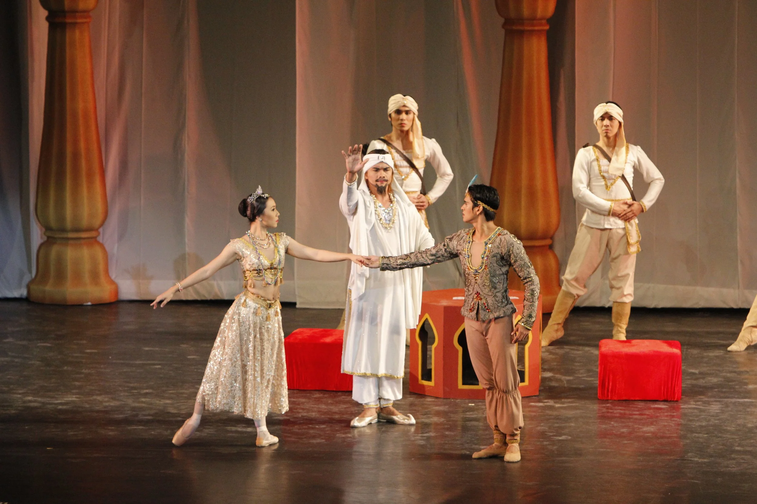    The Rajah Dugmanta (Marcus Tolentino, center) approves of the union between his daughter Gamzatti (Mylene Aggabao) and the warrior Solor (Rudy De Dios) in  La Bayadere  (2013). But when they learn that Solor has already promised himself to Nikiya,