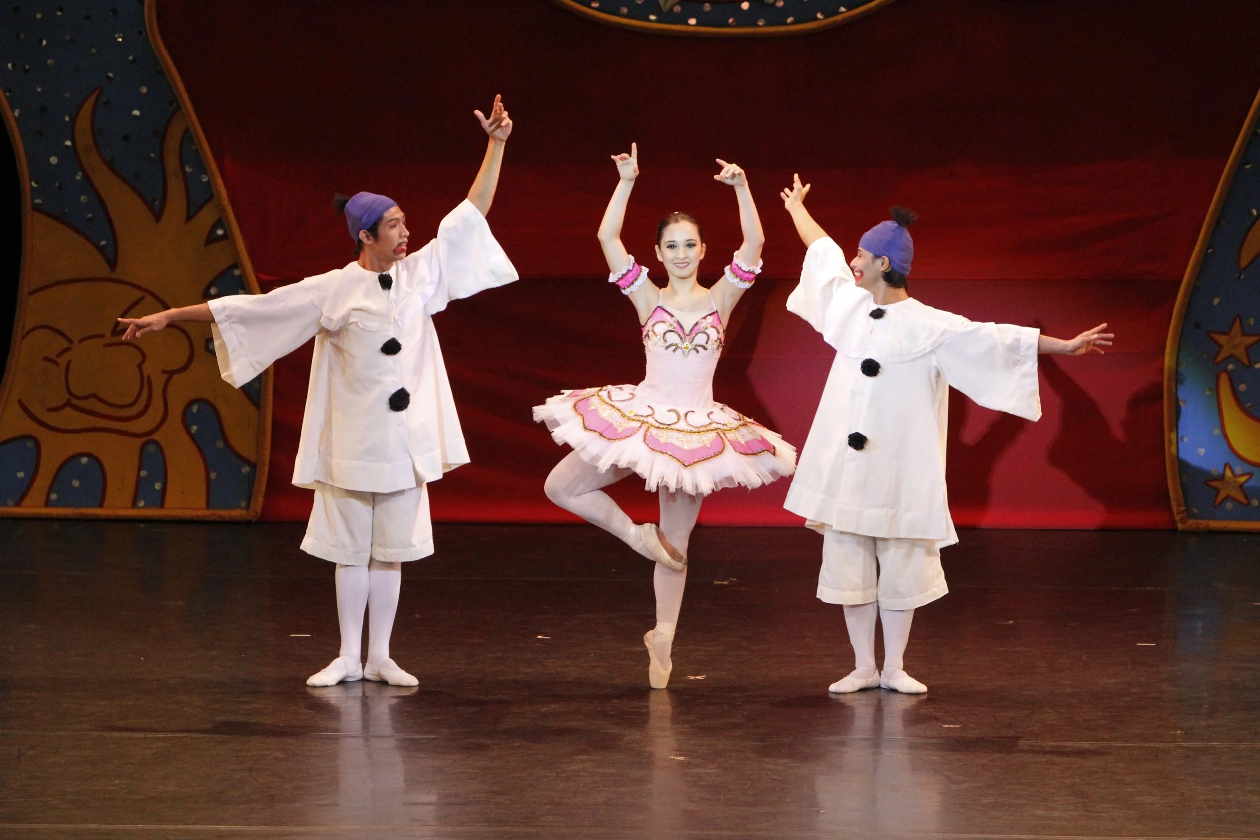    The Fairy Doll (Missy Macuja Elizalde, center) is caught in a love triangle as the sad clown (Glenn Ragel, left) and the happy clown (Alvin Santos) clamor for her attention. The  Fairy Doll  pas de trois, with choreography by Nikolai and Sergey Le